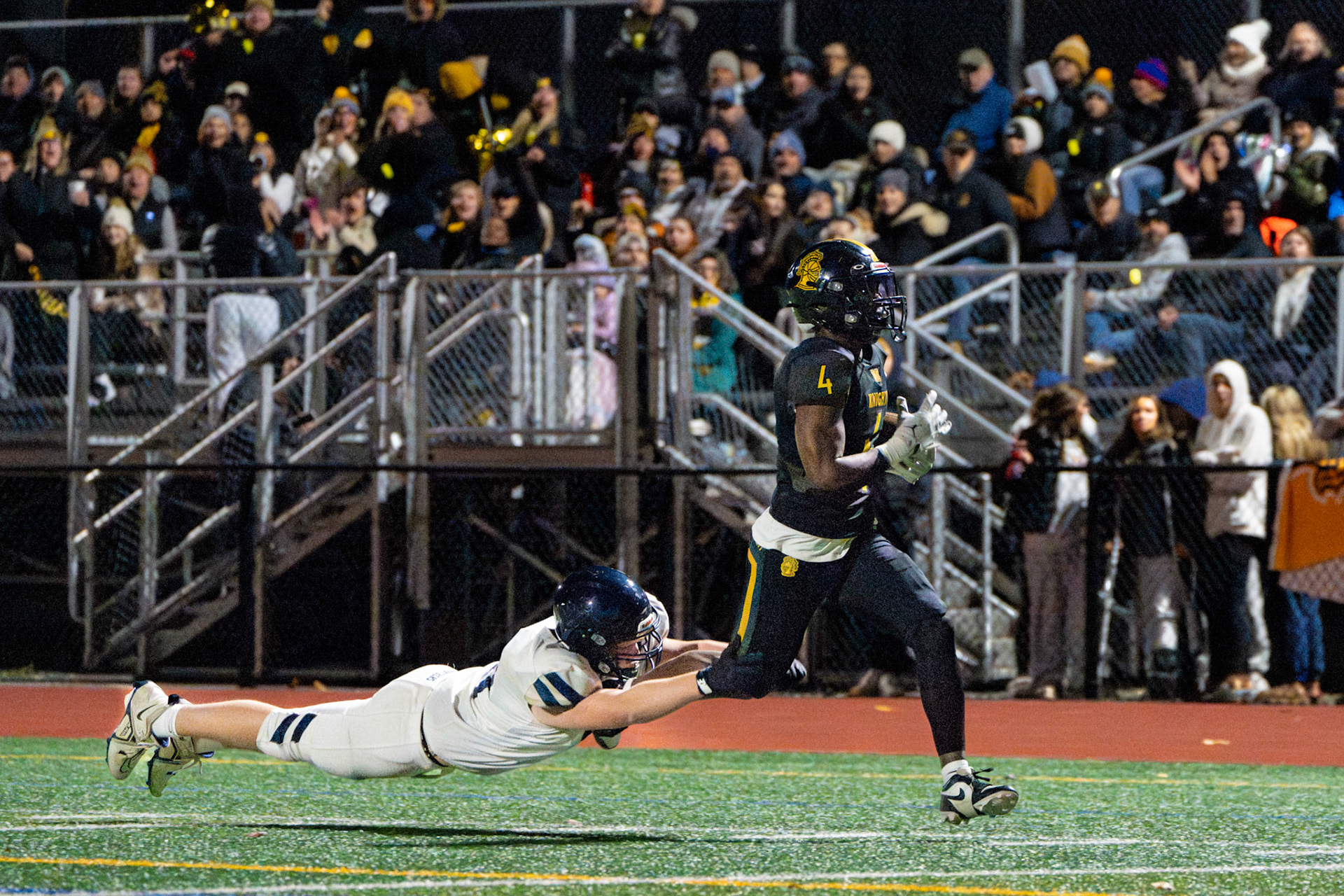 McQuaid Jesuit High School running back Allen Nesmith avoids tackle attempts to score a touchdown against Pittsford, Nov. 1, 2024, in Brighton, N.Y.