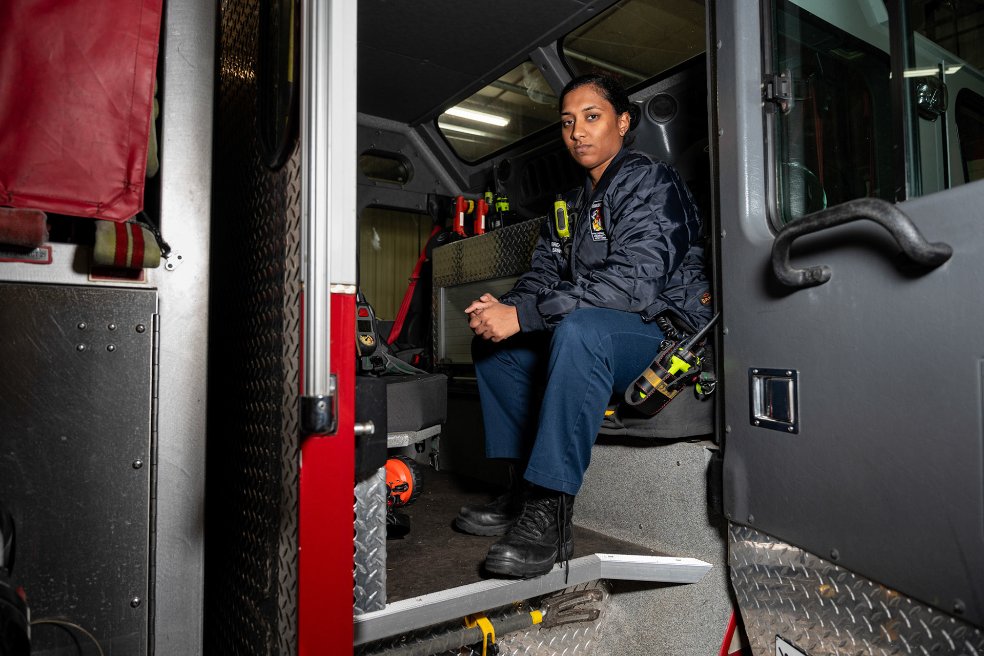 Surya Srinivasan sits in a fire engine at Henrietta Fire Department Station 3, Oct. 18, 2024, in Henrietta, N.Y. Srinivasan is a volunteer firefighter for the Genesee Valley Fire Department.