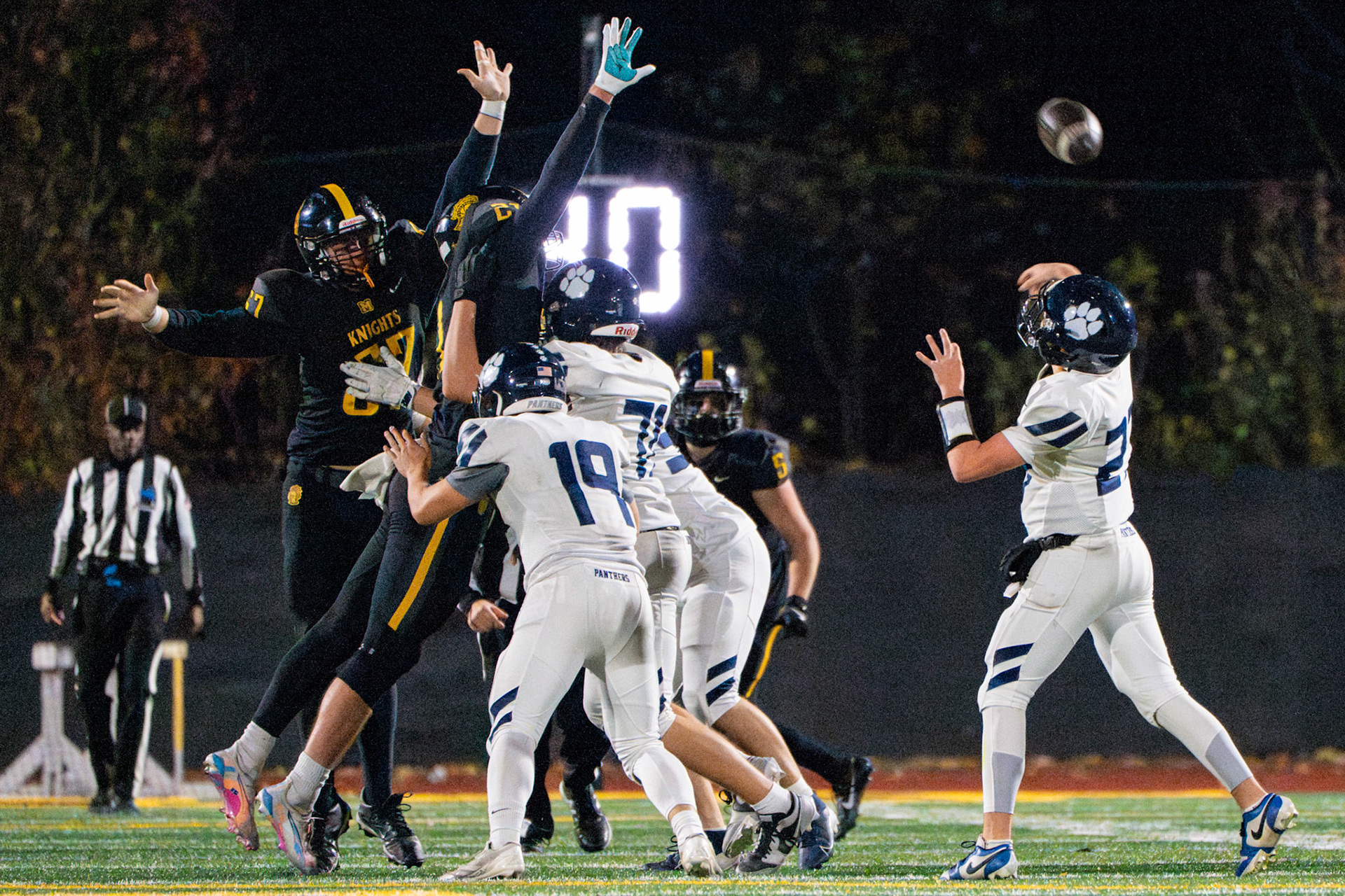 McQuaid Jesuit High School football players attempt to block a throw from Pittsford’s Mason Harrington, Nov. 1, 2024, in Brighton, N.Y.