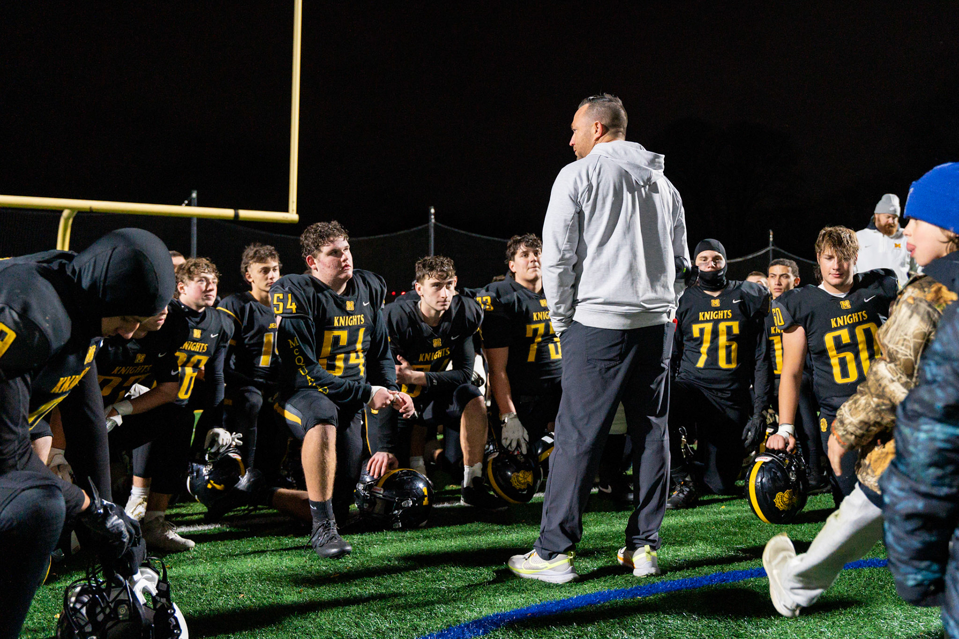 McQuaid High School football coach Bobby Bates addresses his team after a 35-7 win against Pittsford High School in a sectional playoff game, Nov. 1, 2024, in Brighton, N.Y.