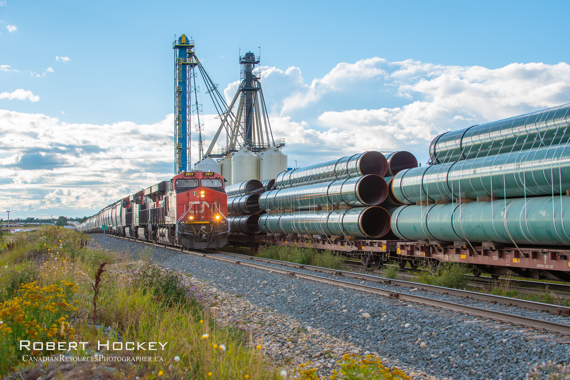Trains bring the pipe, and pick up the grain.