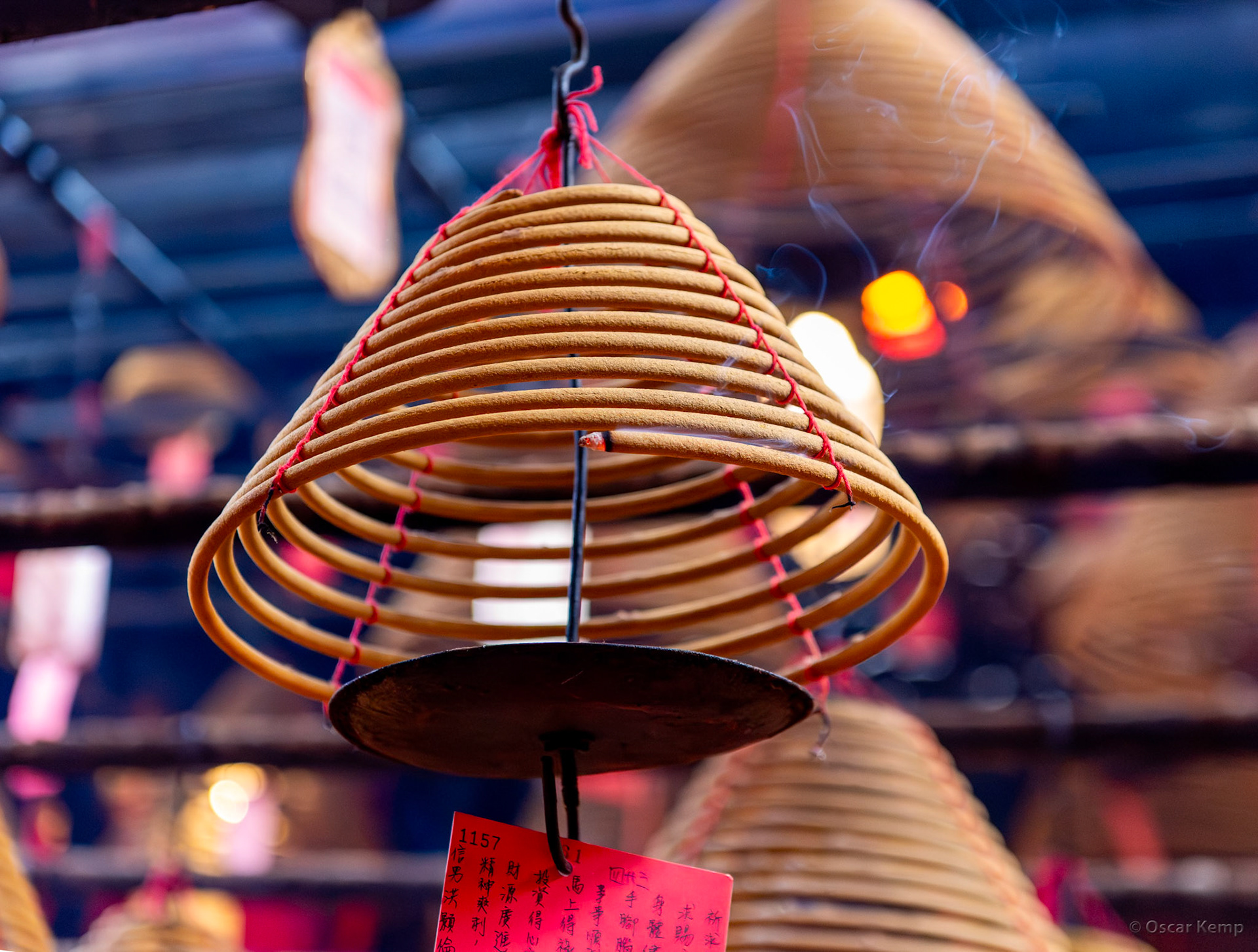 Man Mo Temple / Burning incense rolls; the smoke carries the wish (written on the red card) up to heaven [[China, 2025 05]