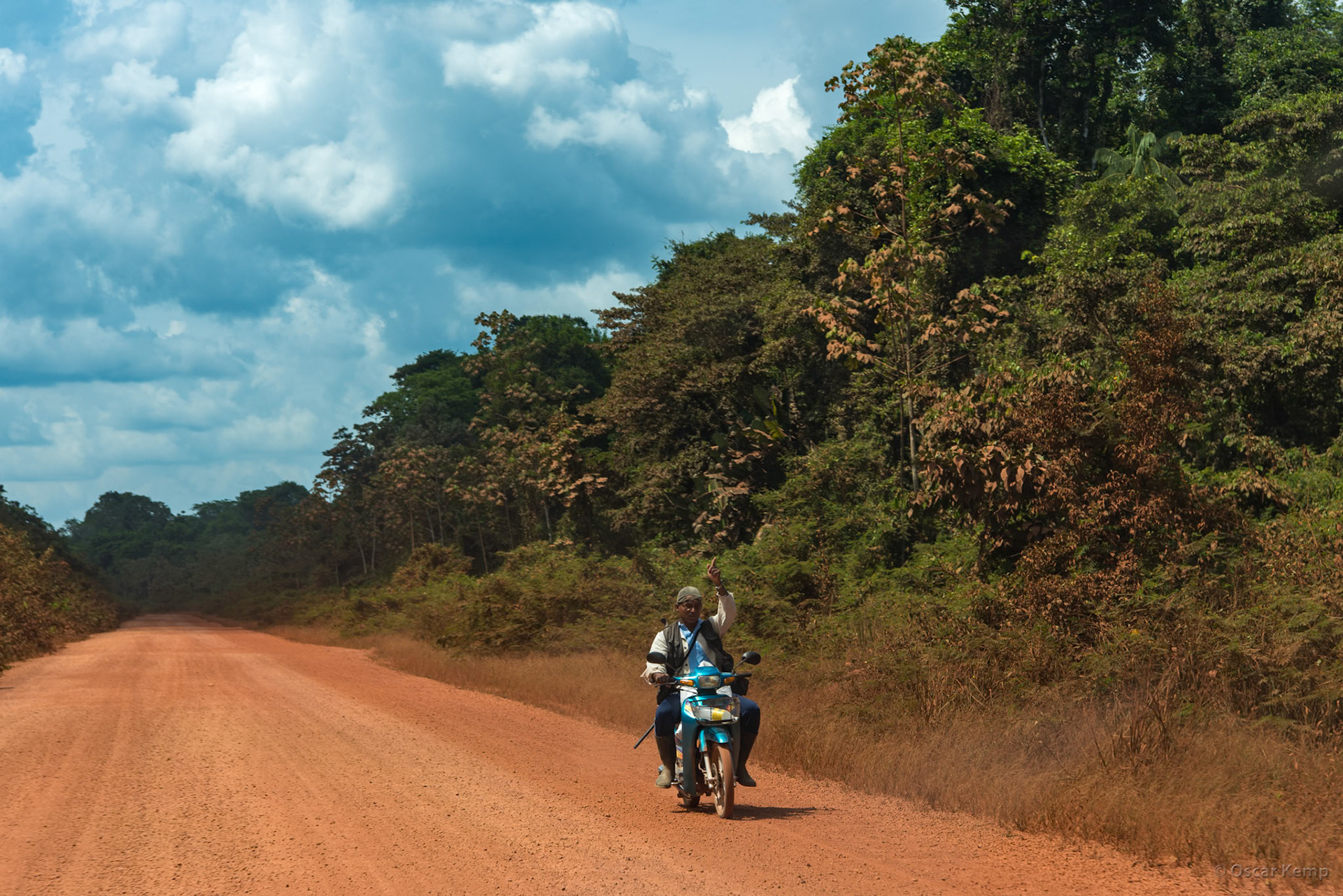 Southern Oost- West verbinding near Apura / Lone moped rider (hunter?) braves hot and dusty dirt road [Suriname, 2018 10]