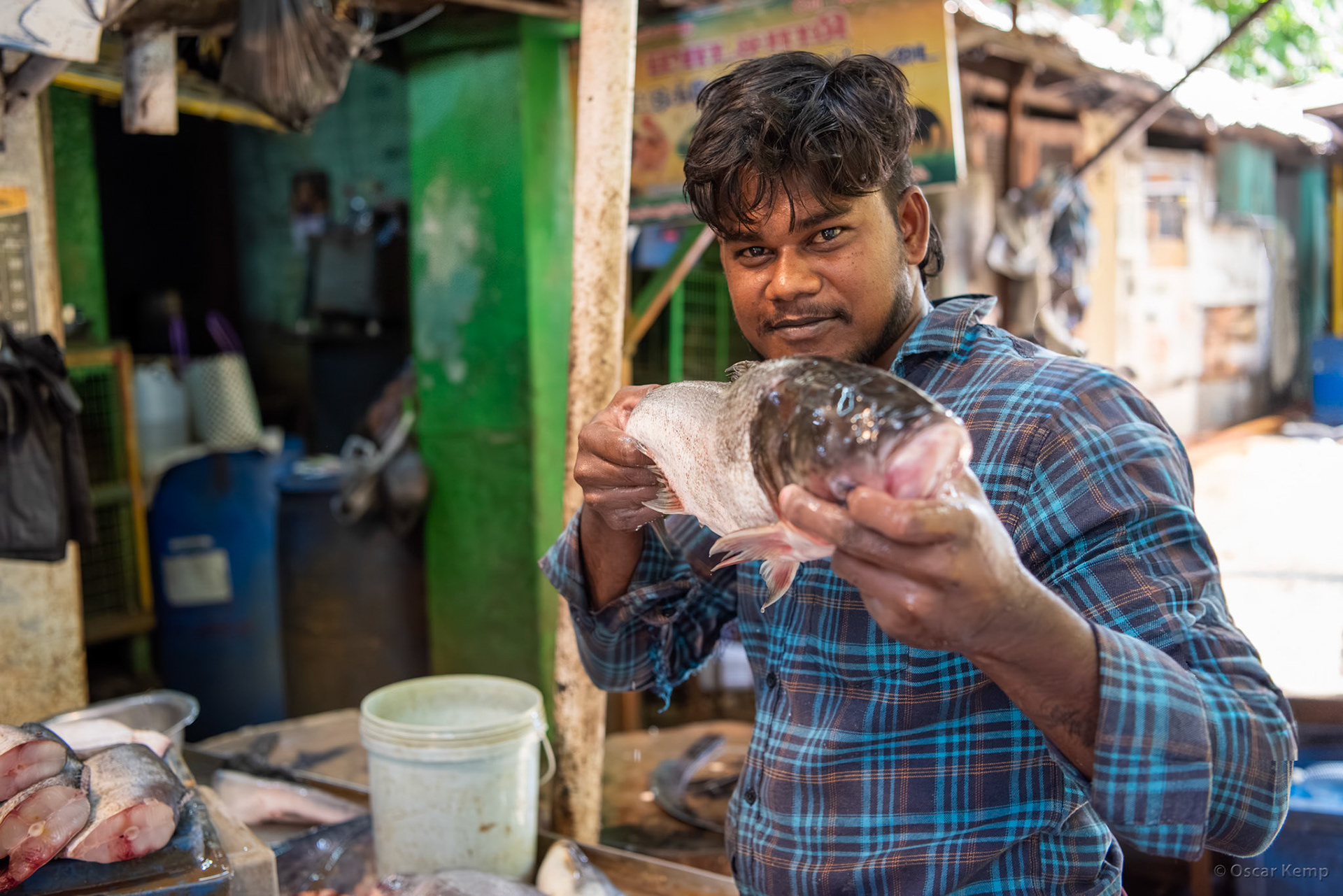 Madurai / Young fishmonger boldly promotes his wares near Sri Veli St [India 2024 09]