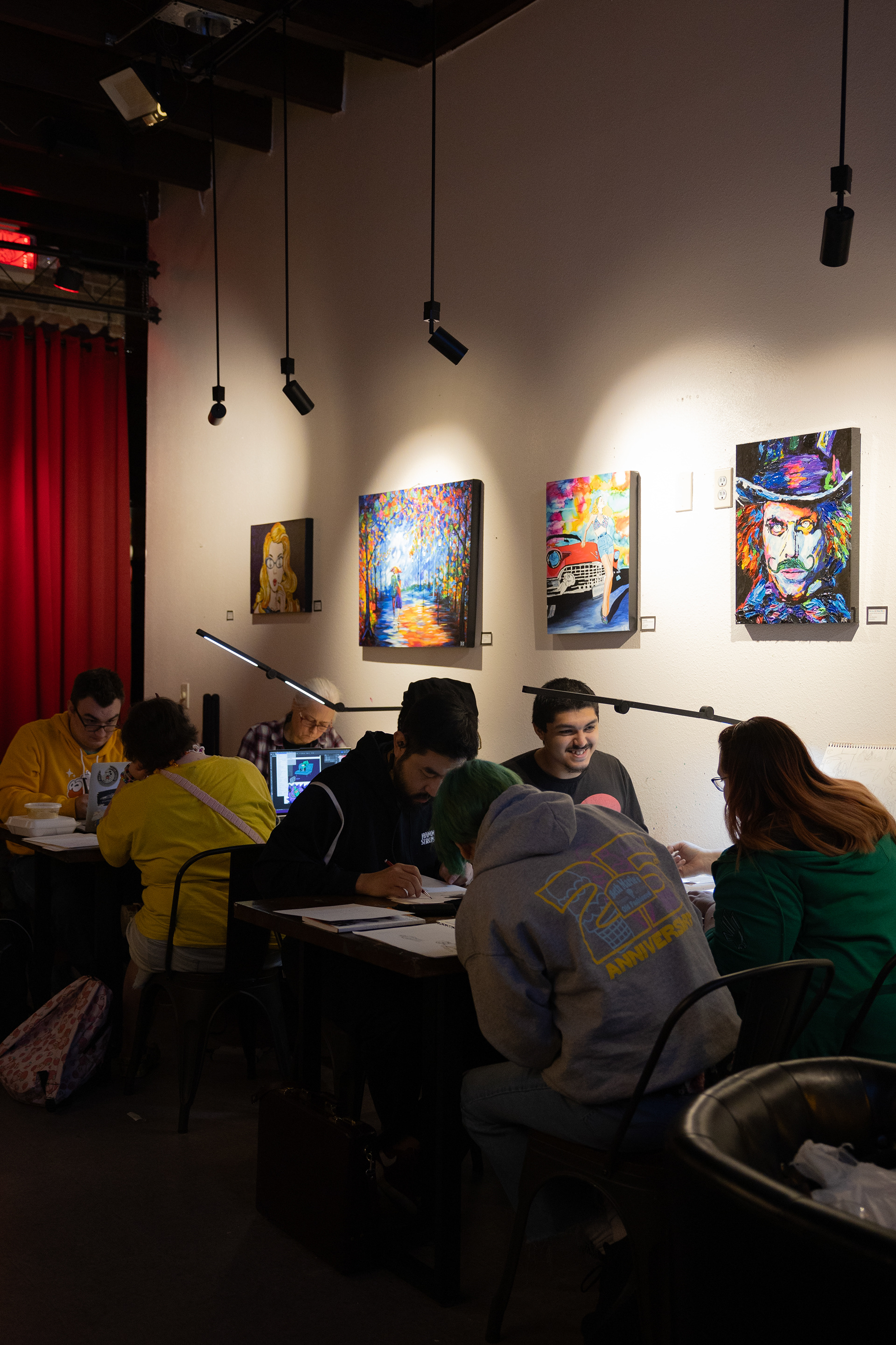 Participants in the 3rd annual Attack the Page mini comic marathon work on their comics alongside each other at Bramlitt's Yellow Dog Art Bar and Gallery. 