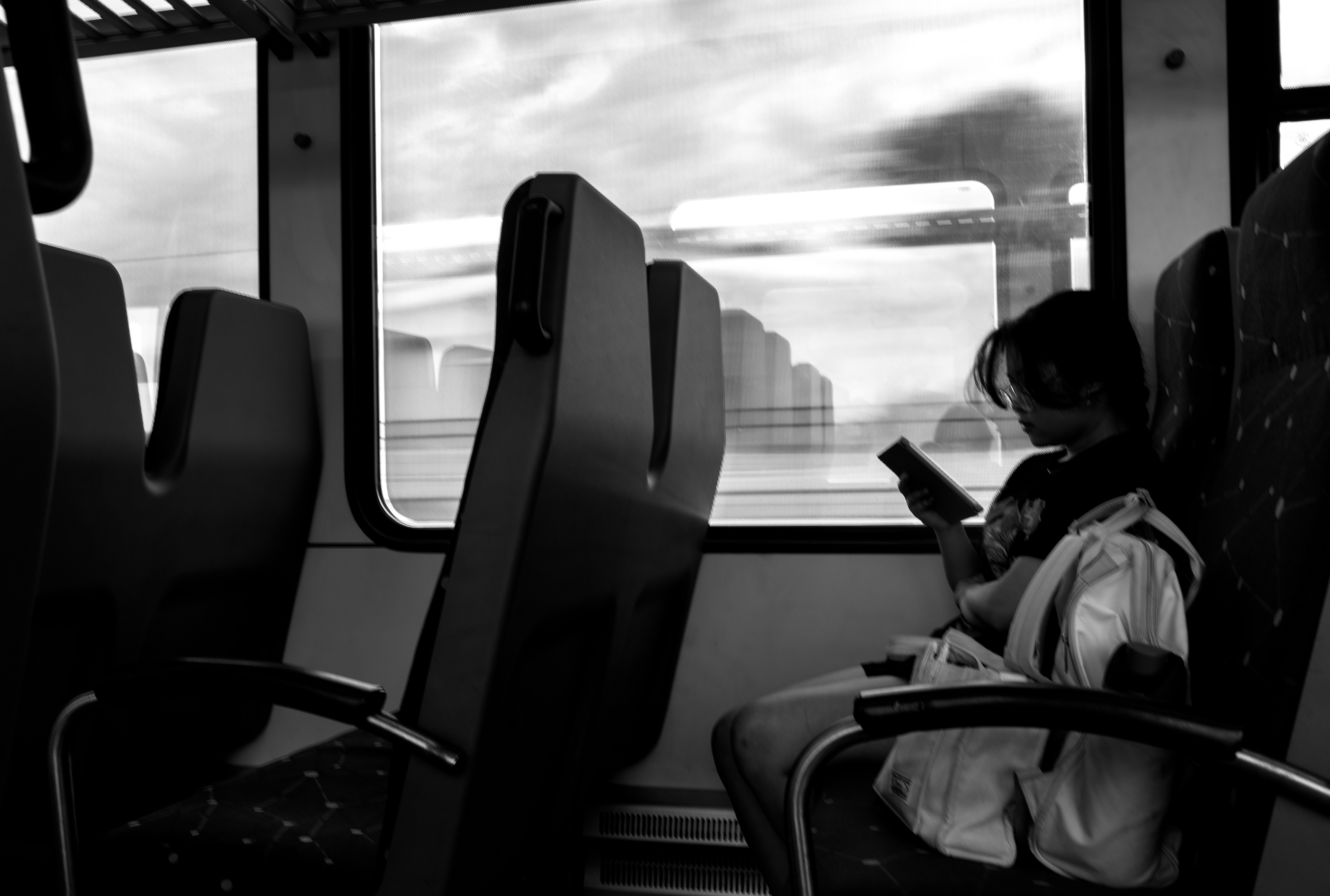 Charlotte Tran, an accounting student at the University of North Texas, reads on her Kindle aboard the A-train on her way to class. As the train rushes forward, Tran is still, illustrating the delicate balance of movement and pause that defines the everyday rhythm of public transit.