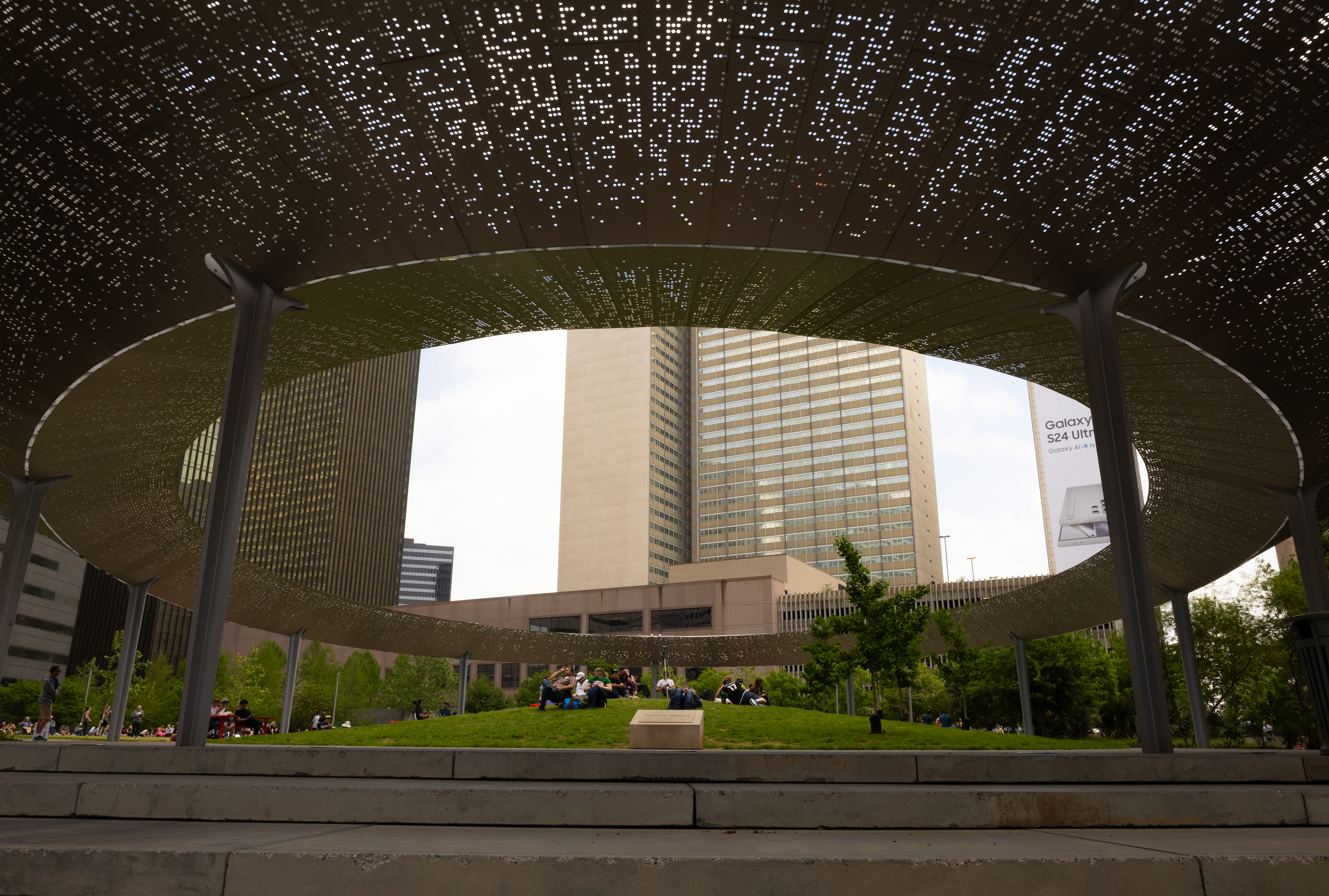 People gather at Pacific Plaza Park to watch the solar eclipse as a community. 