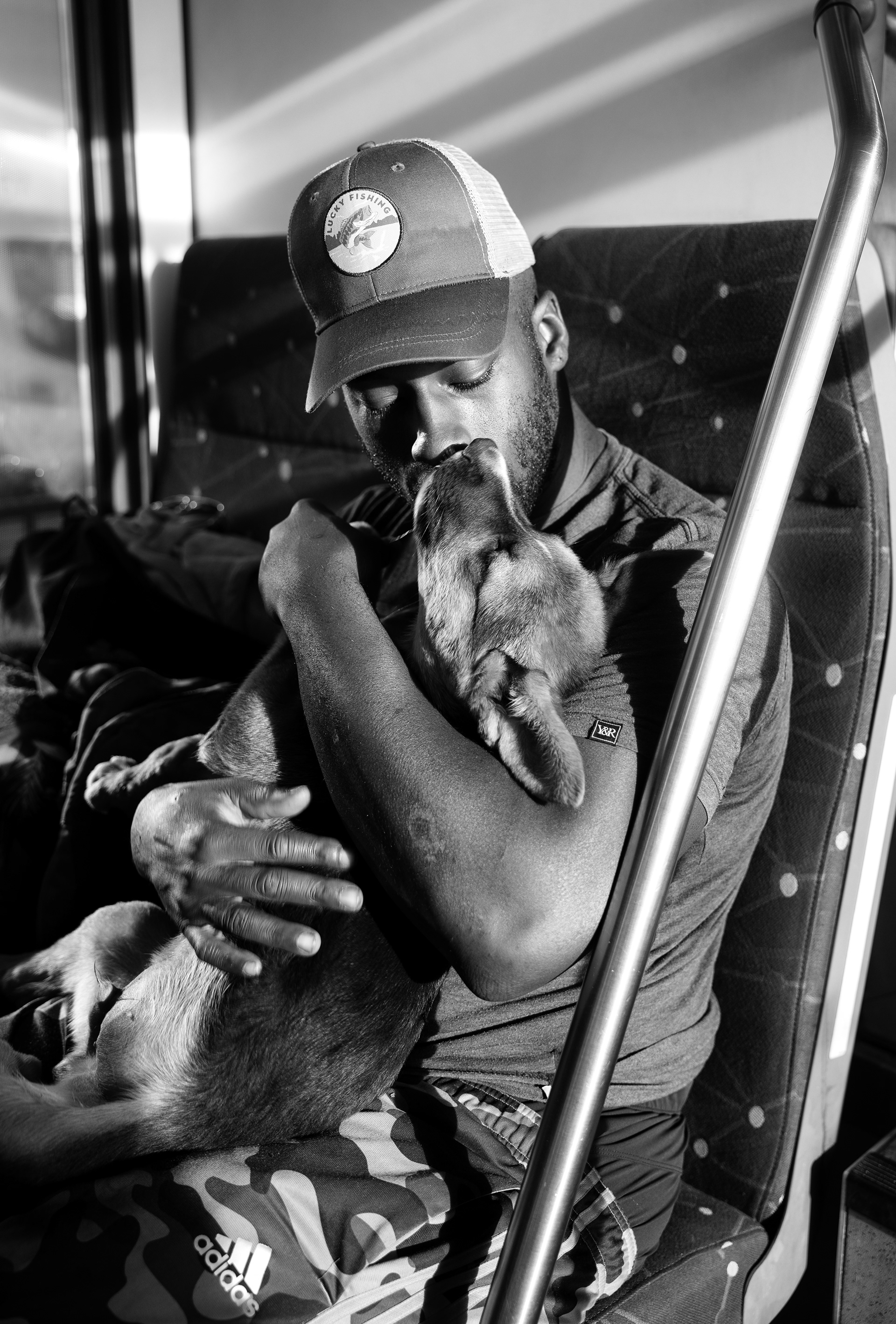 Tay Wallace kisses his dog, Junior, while riding the train. “I’m currently between places and trying to get myself together,” Wallace said. “I ride the DCTA a lot... from Denton to Dallas to escape the heat or the weather, especially now that I have the dogs. The A-train is always quiet and air-conditioned—it’s peaceful.” 