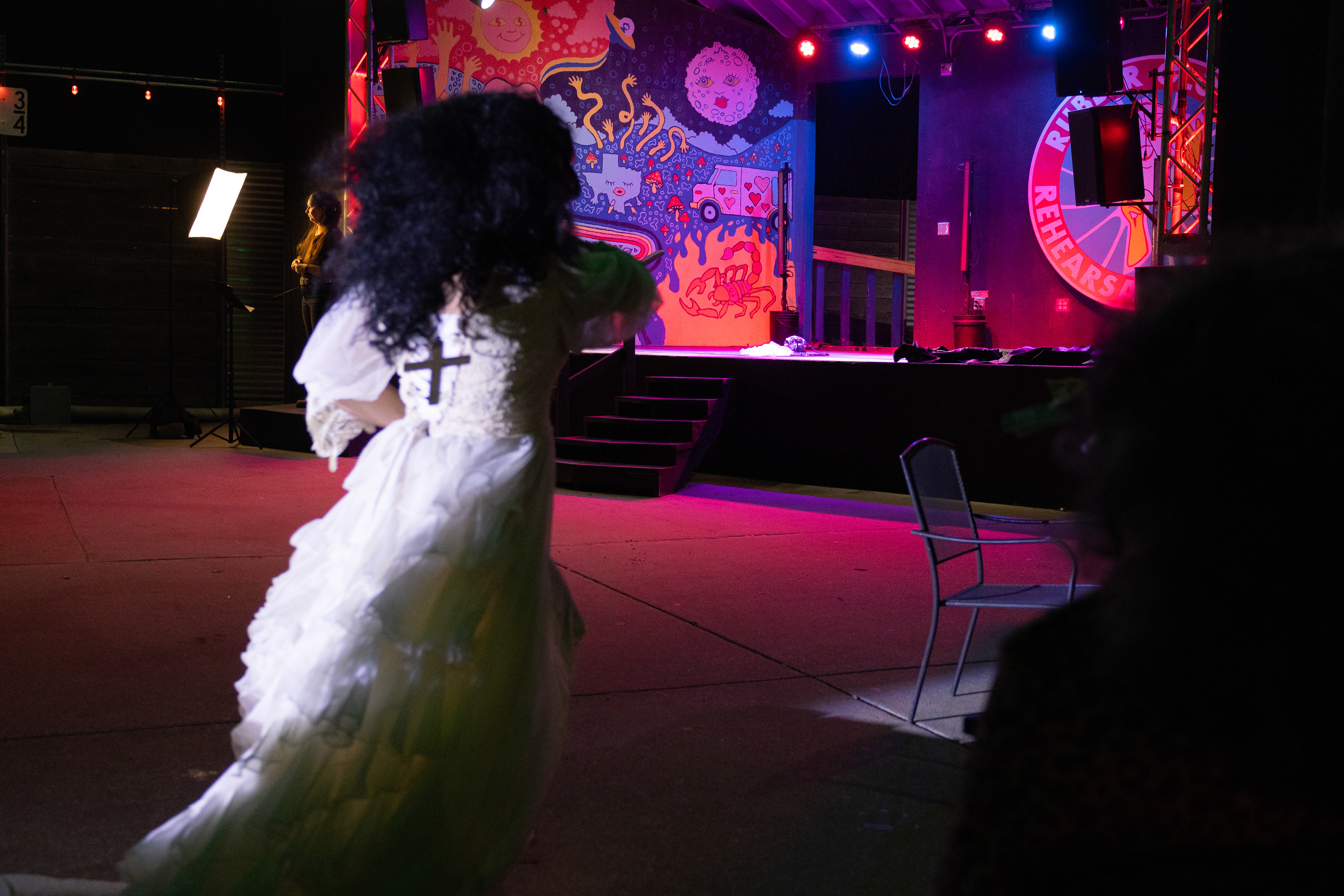 Enchantress Venus Mystique runs as if she is a runaway bride during her performance at Glitterbomb’s weekly show at Rubber Gloves Rehearsal Studio on March 6. A cross dangled down her back to exemplify the theme of her performance. Her show was about the duality of man and alluded to criticisms of the Christian Church. 