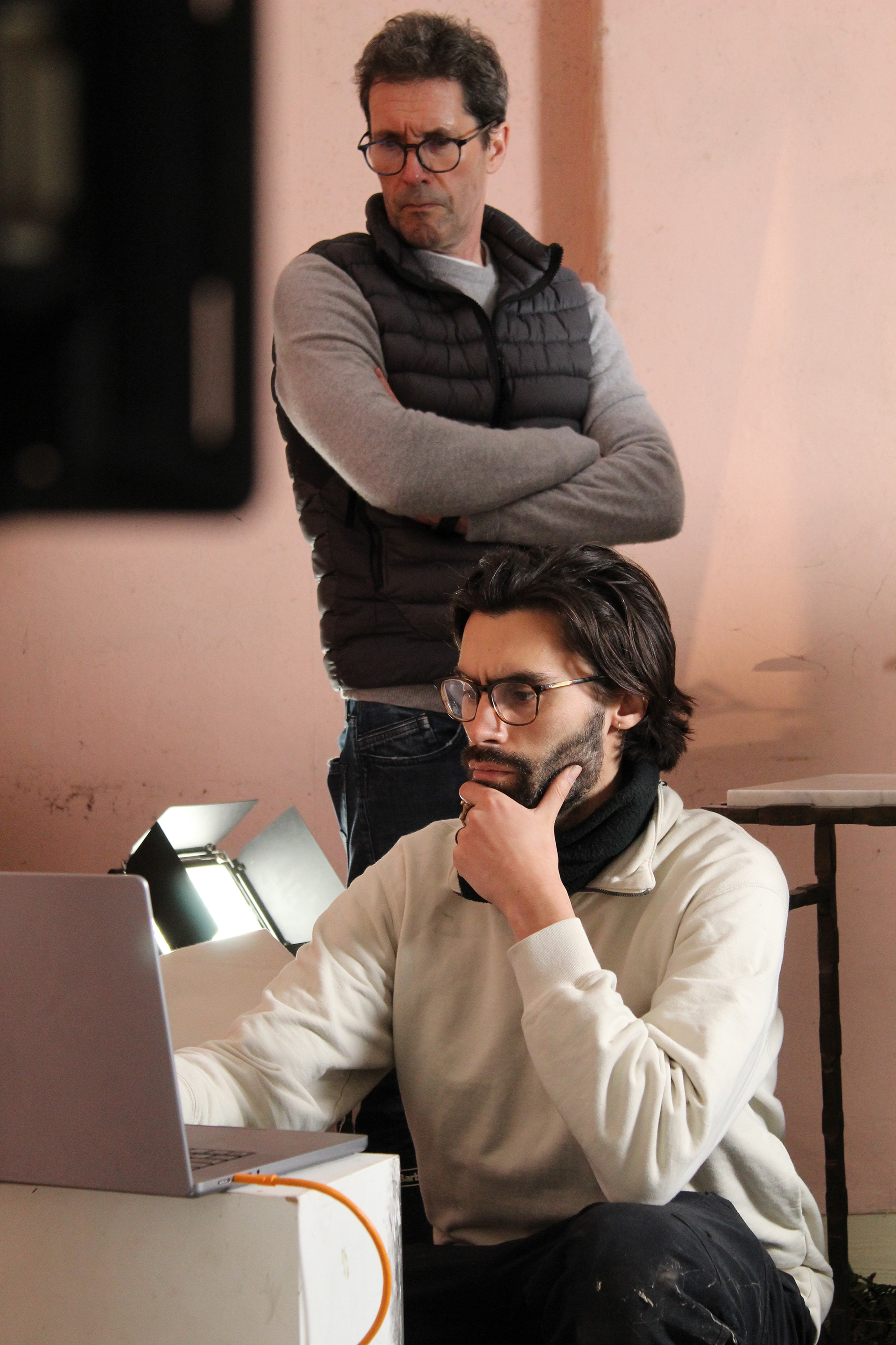 Photographer Laurence Hills, puzzles over images for the 'Maddie Rose Hills Collection' with Porta Romana's Creative Director, on set in an abandoned cottage in Hampshire.