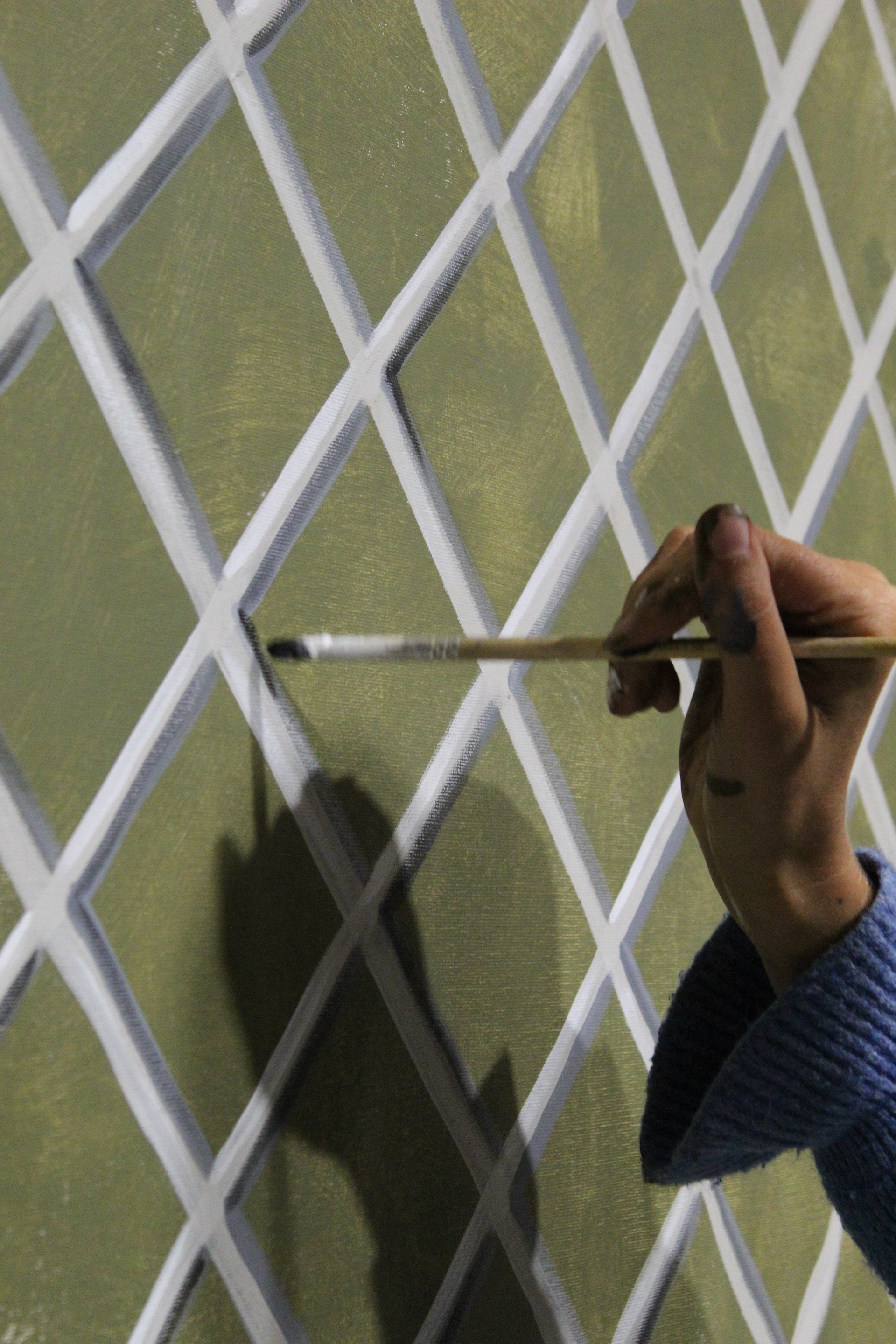 Artist Meg Boscawen paints a backdrop for the Autumn 23 Collection, inspired by the circus.