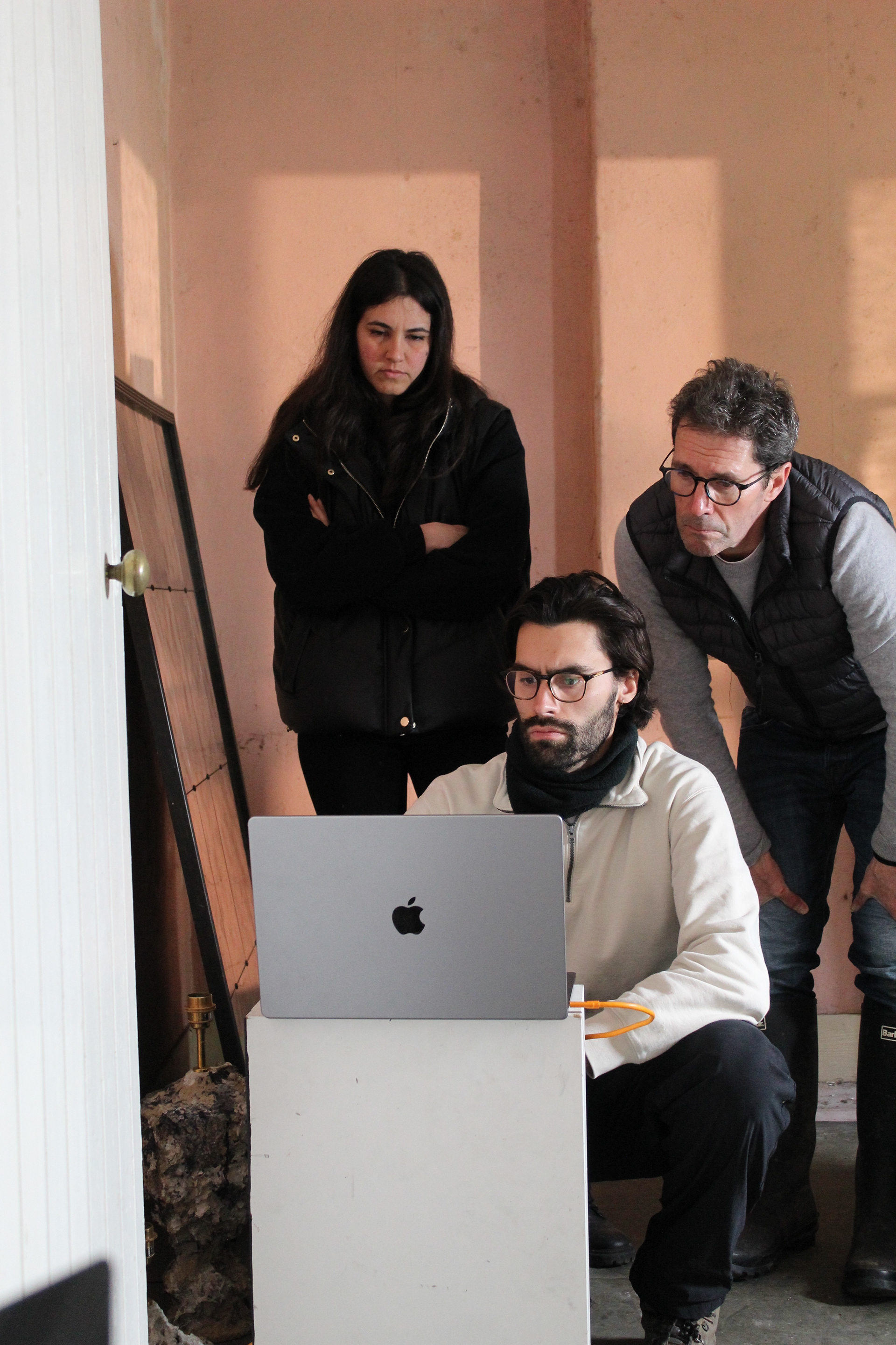 Photographer Laurence Hills, puzzles over images for the 'Maddie Rose Hills Collection' with Porta Romana's Creative Director and Design Assistant Alice, on set in an abandoned cottage in Hampshire.