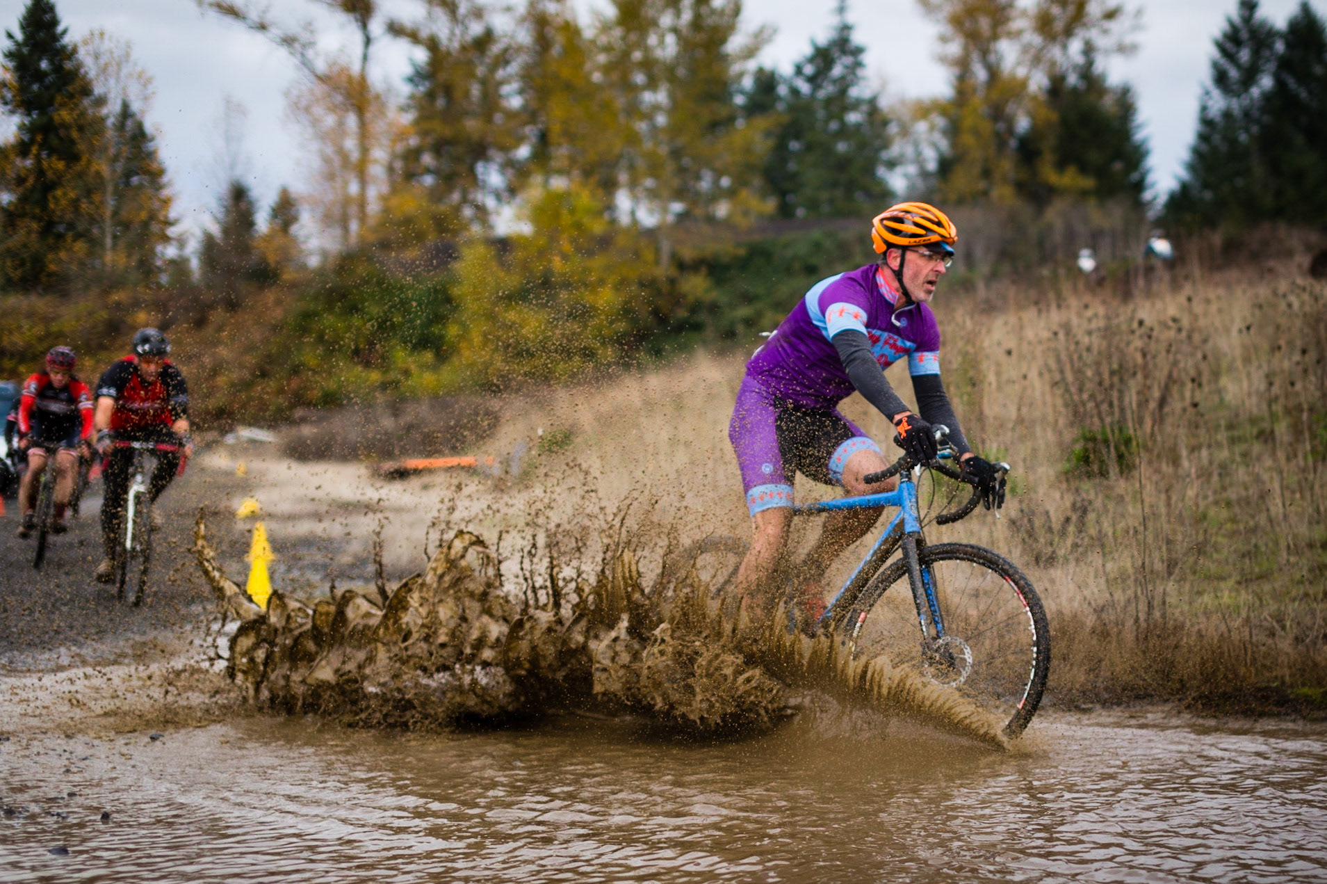A cyclocross rider blasting through a muddy puddle in the Barton Park Cyclocross Crusade race this year. What a fun sport, always increased by heckling and handups!