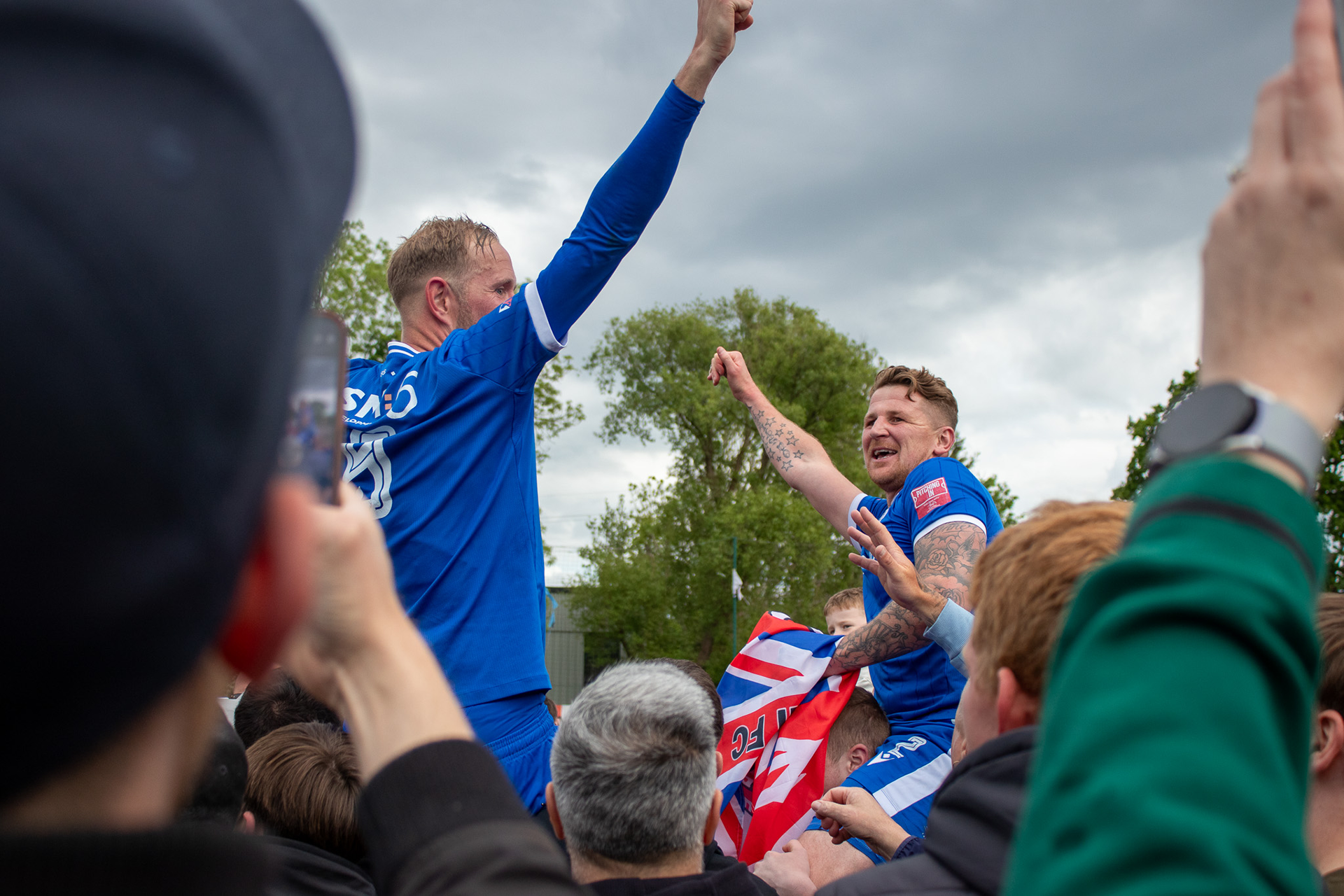 Joe Oaster and Scott Rendell are held aloft by fans as they are promoted.