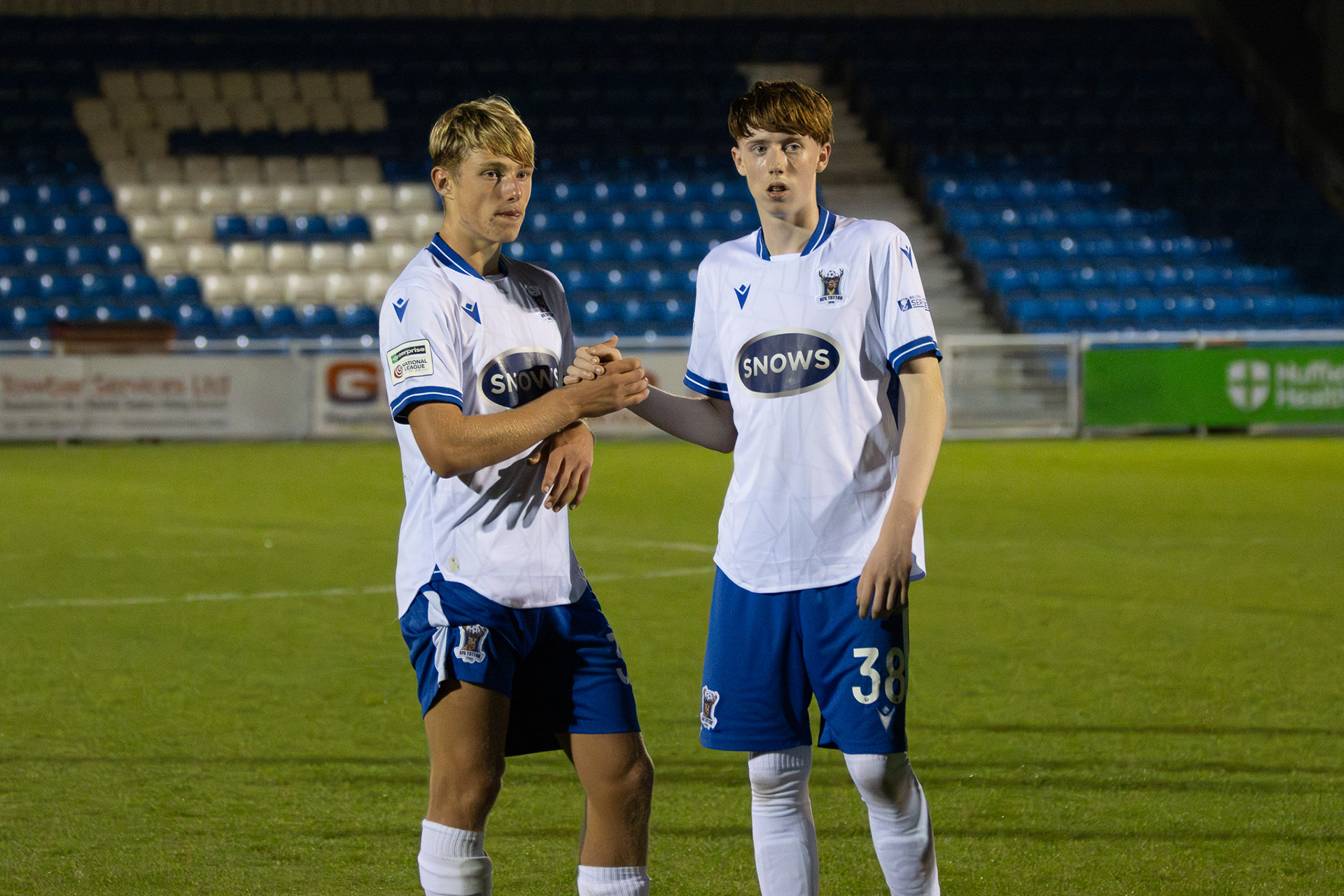 AFC Totton academy graduates handshaking at the end of the match.