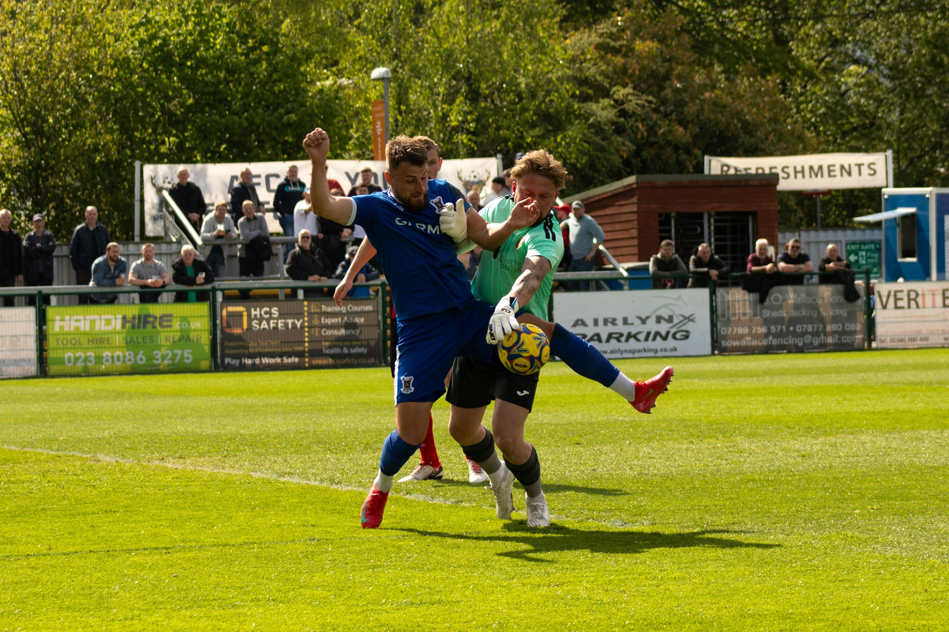 Tony Lee challenges the goalkeeper for the ball.