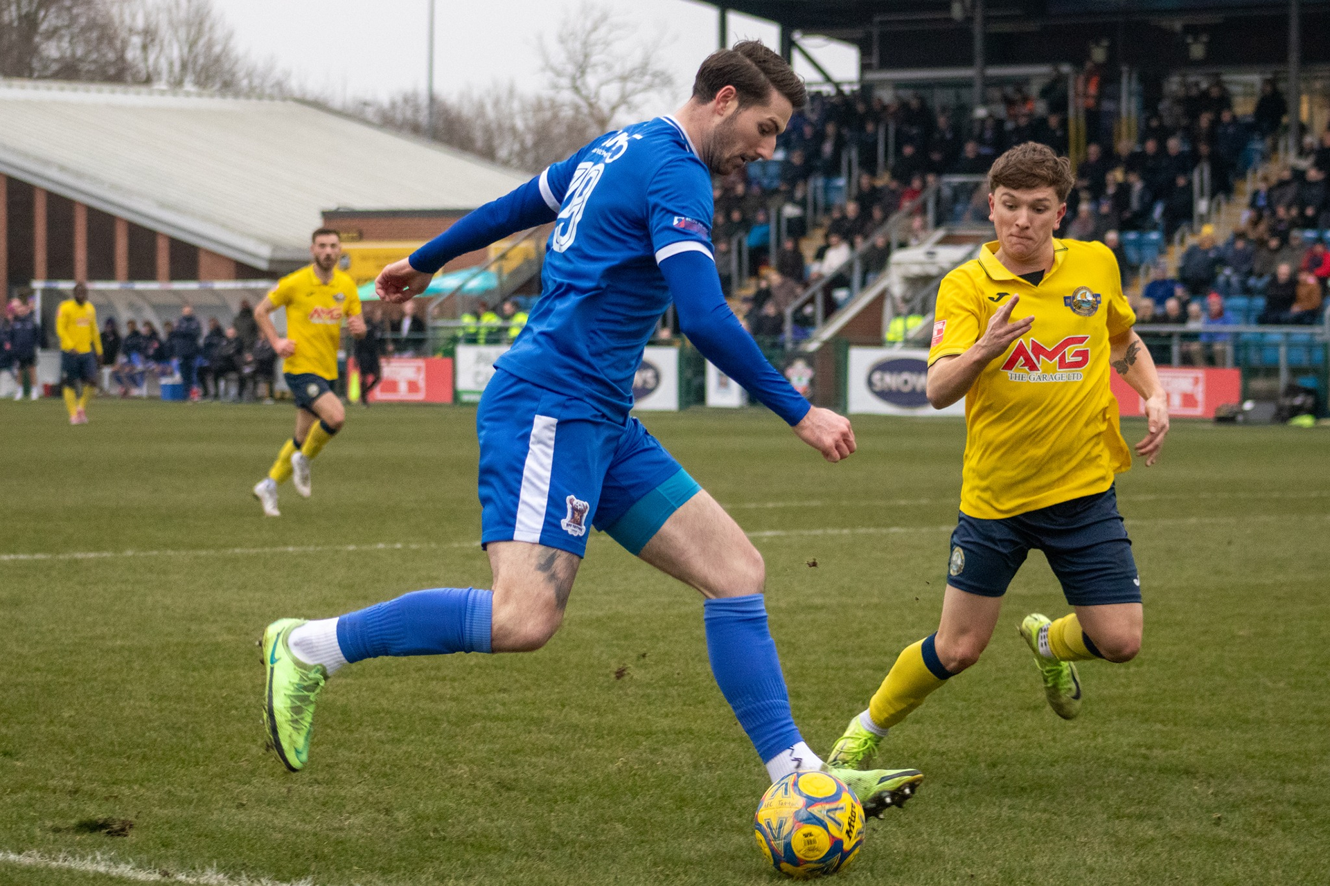 Tom Blair takes on a player.