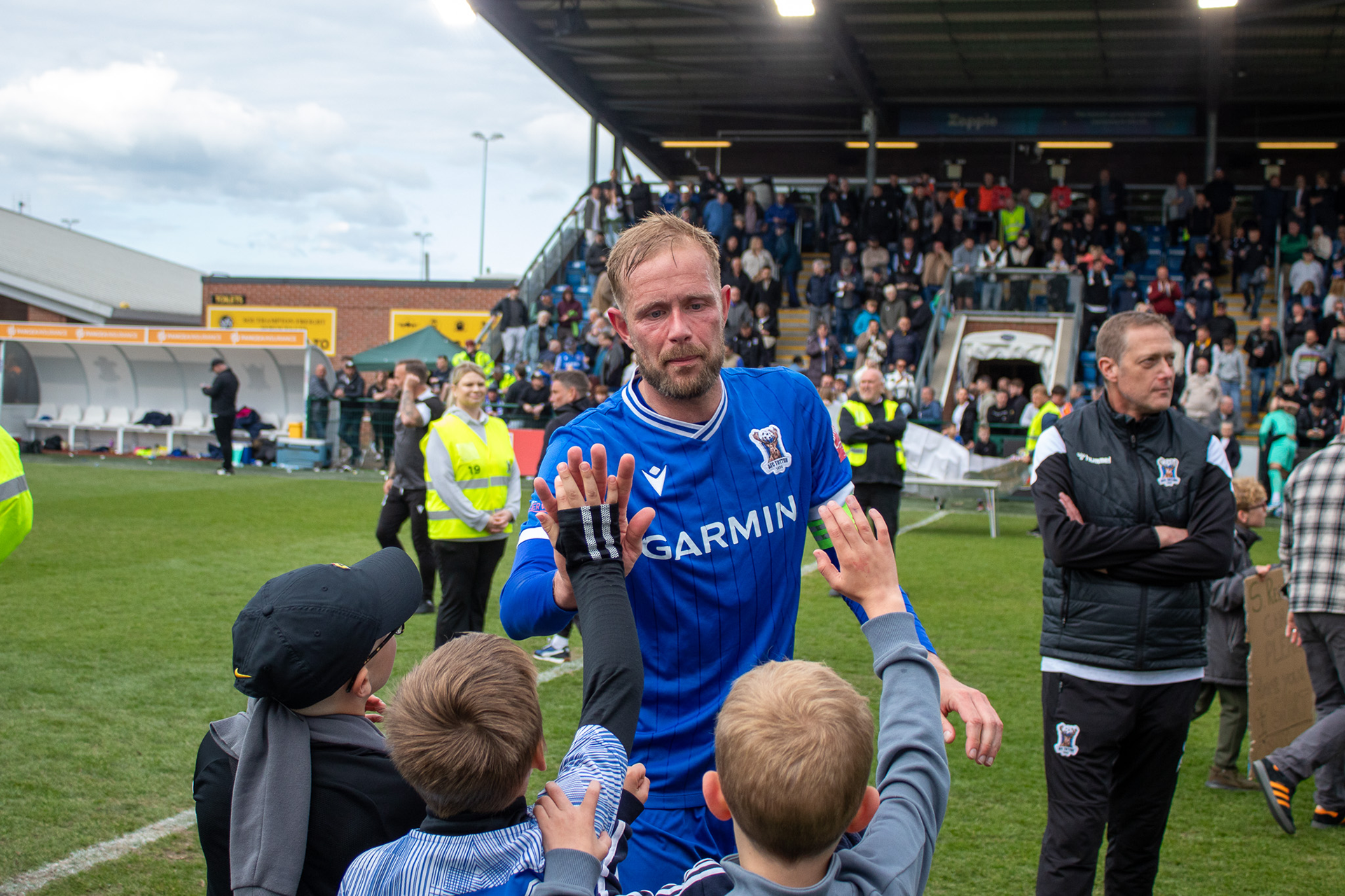 Scott Rendell high fives some young AFC Totton fans who pitch invaded.