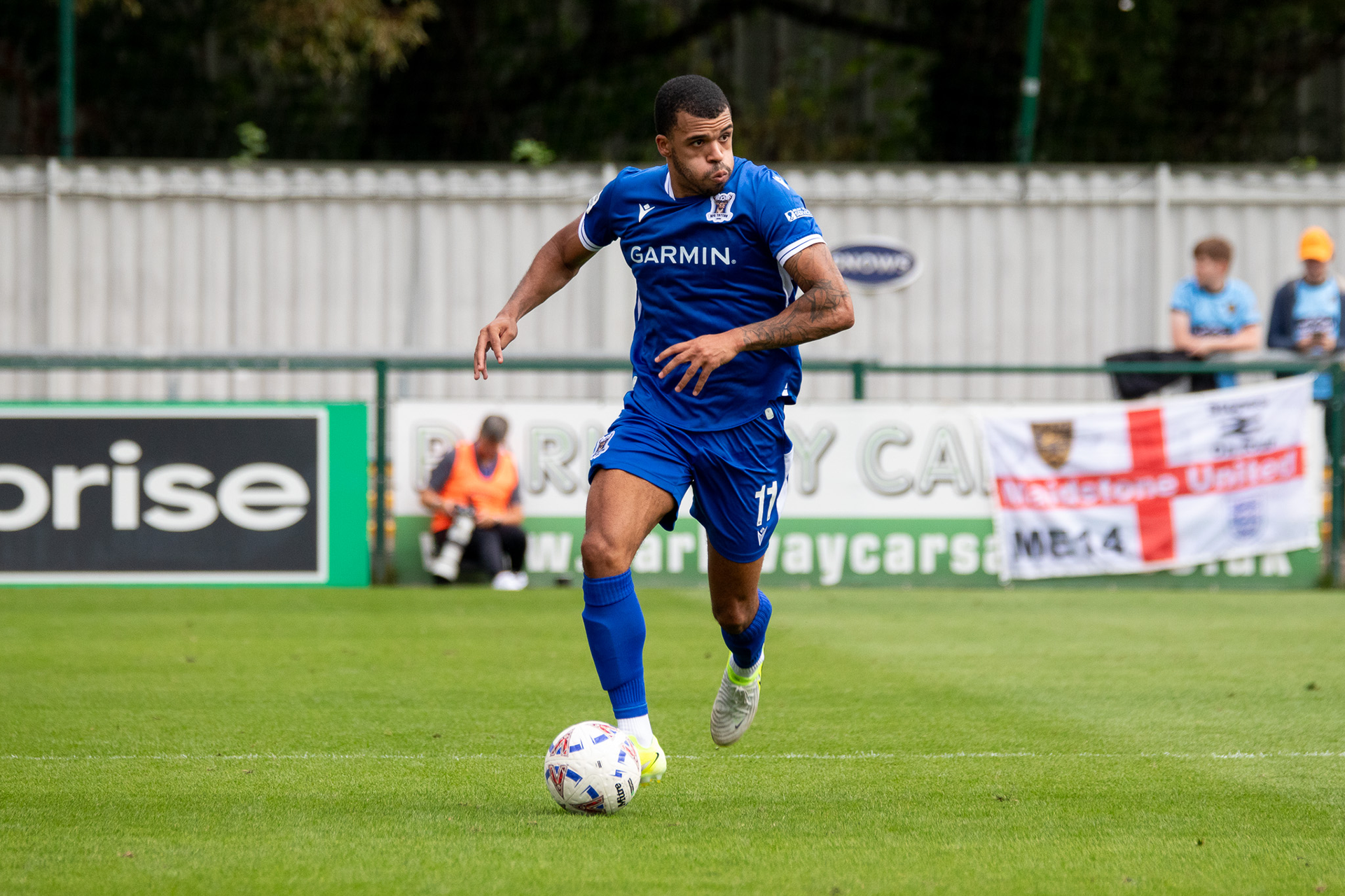 Malachi Linton dribbles the ball up the pitch.