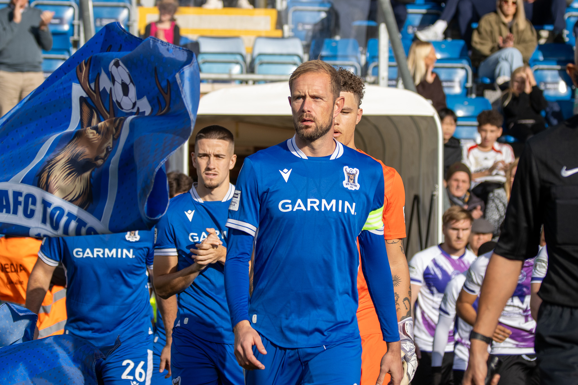 Scott Rendell walks out with the team as they prepare for kickoff.