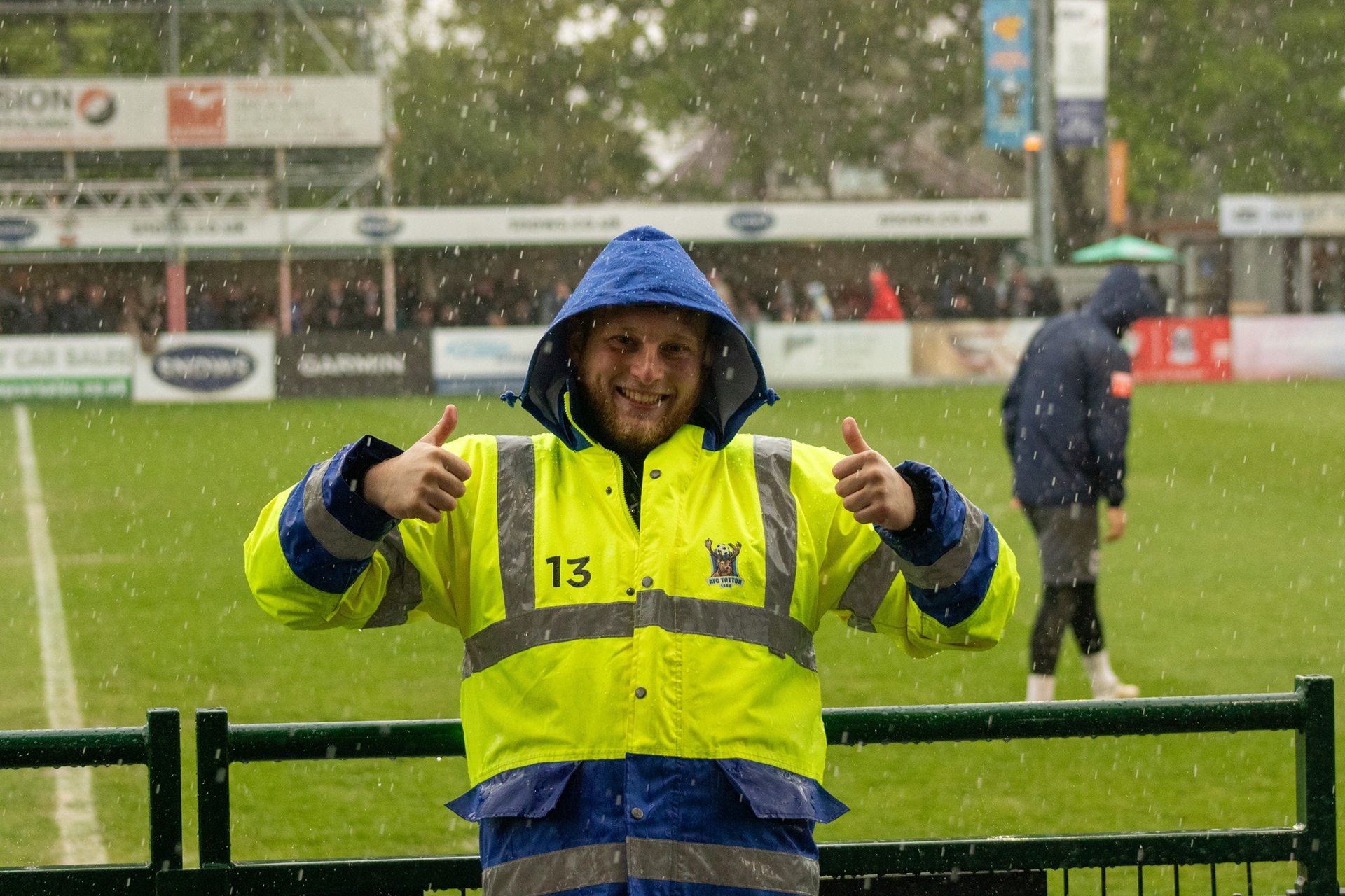 A steward poses in the rain.