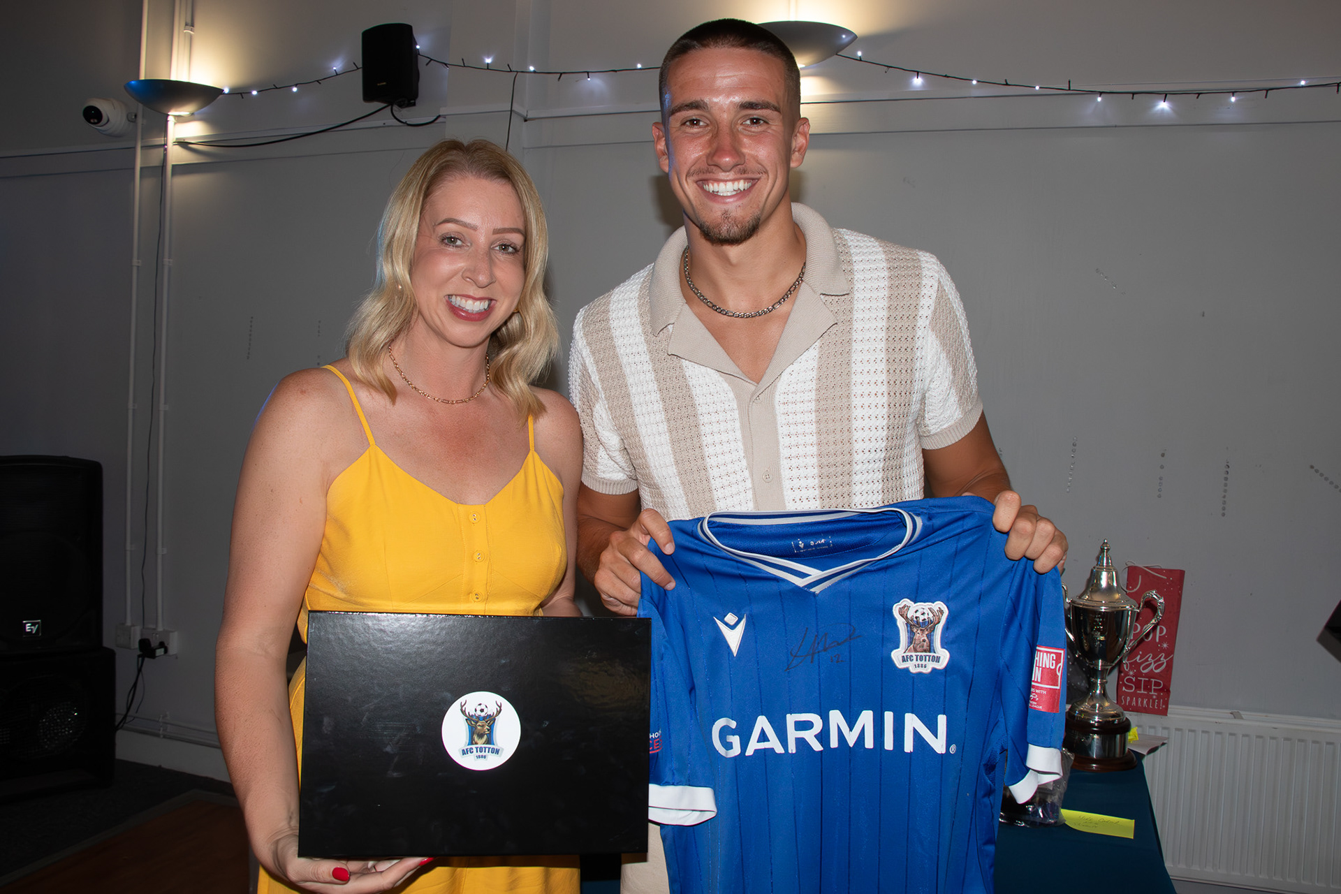 Luke Hallett holds a signed shirt.