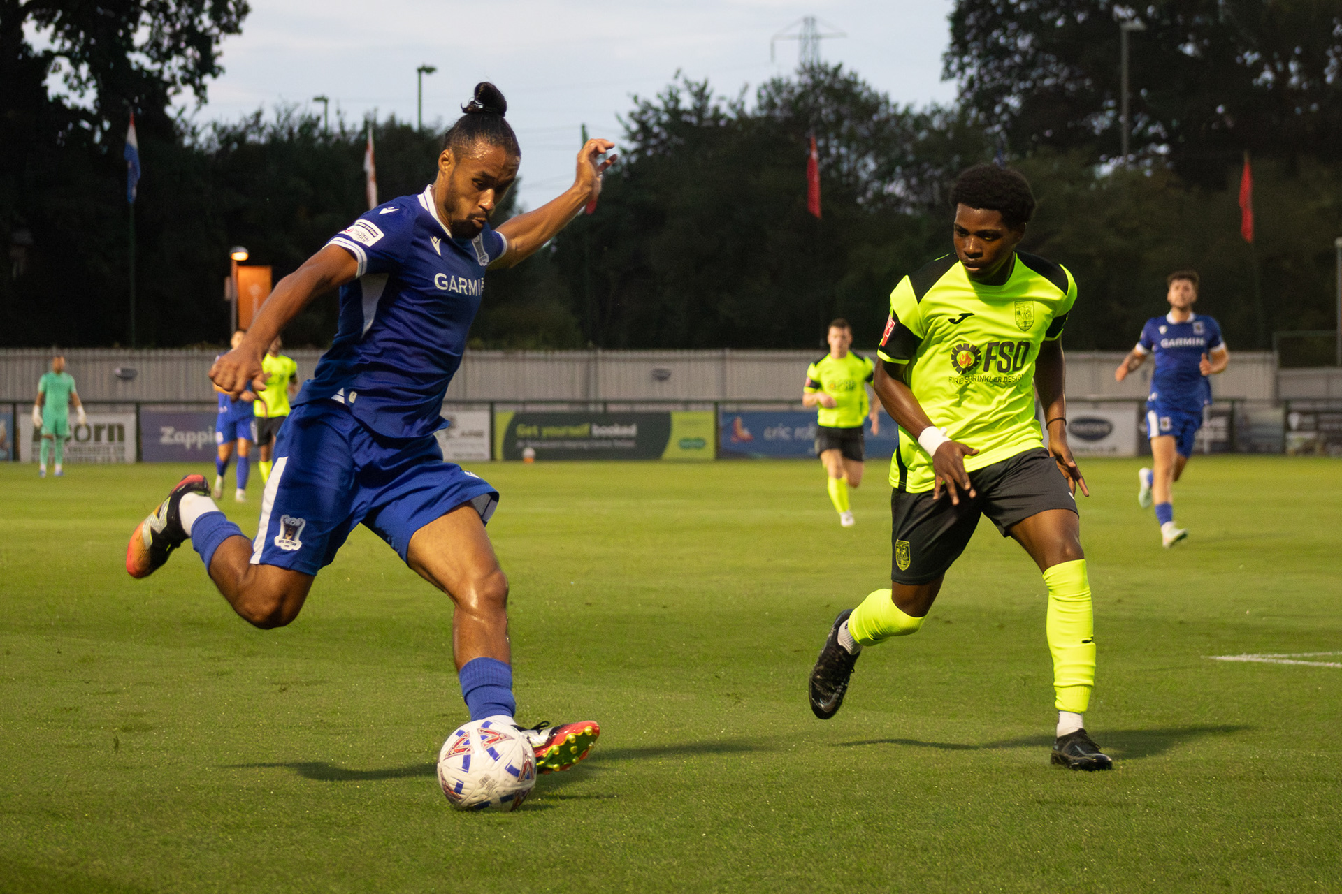 An AFC Totton trialist takes on a Weymouth defender.