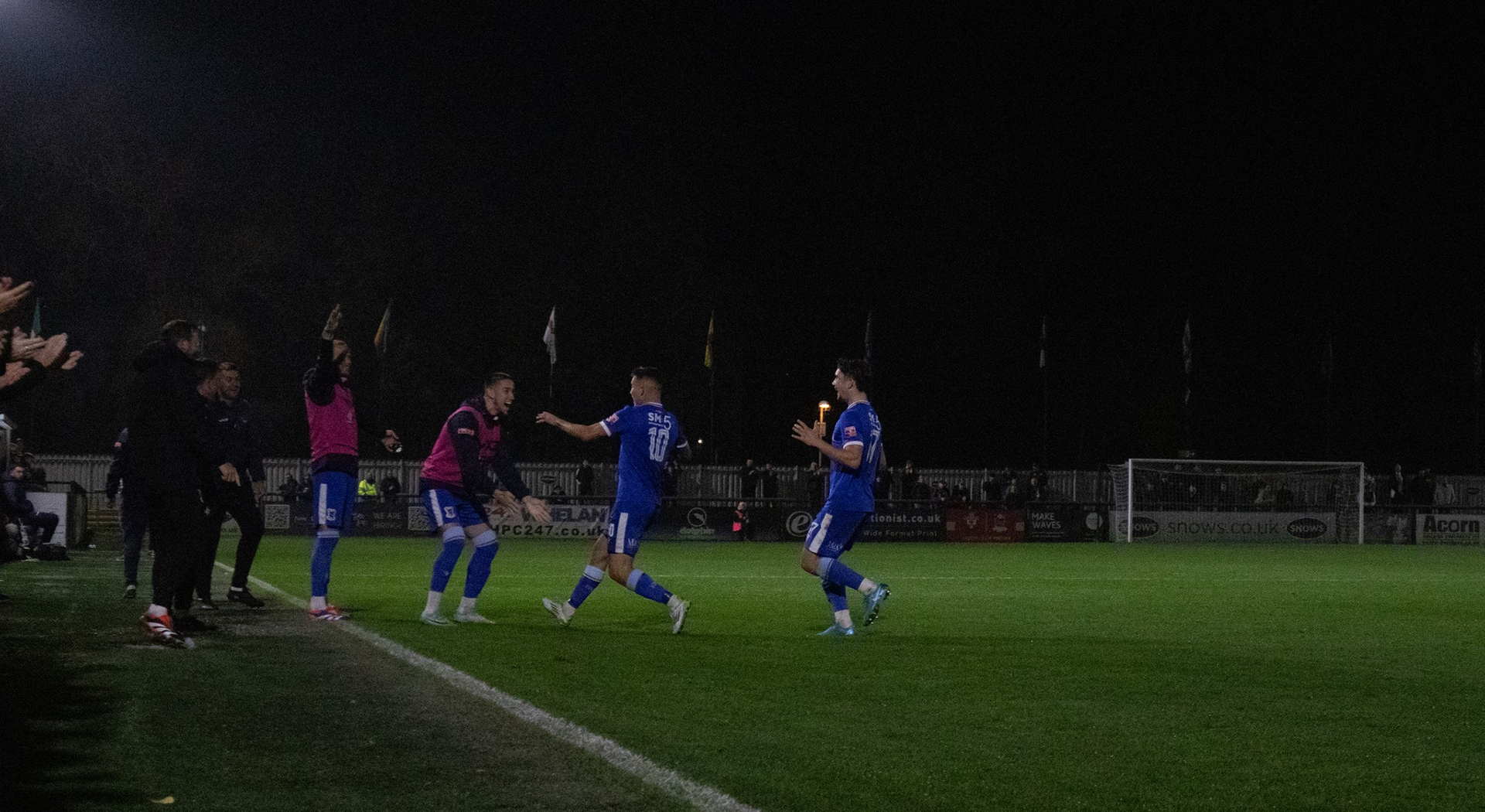 The bench celebrates with Ethan Taylor.