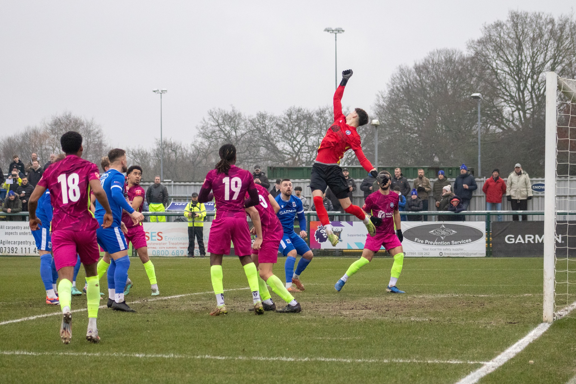 Marlow's goalkeeper punches the ball away.