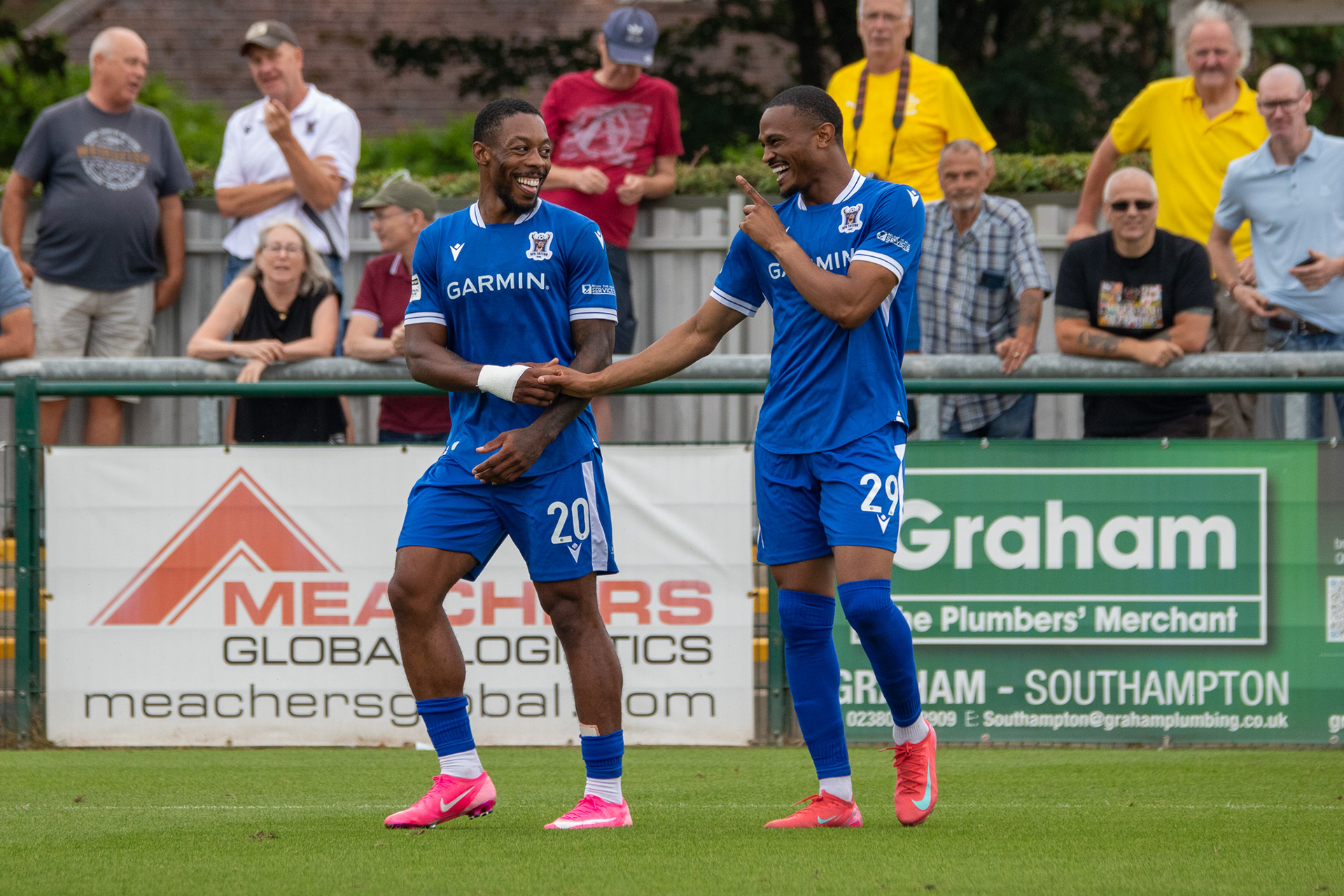 Ryan Jackson and Hisham Kasimu shake hands in celebration.