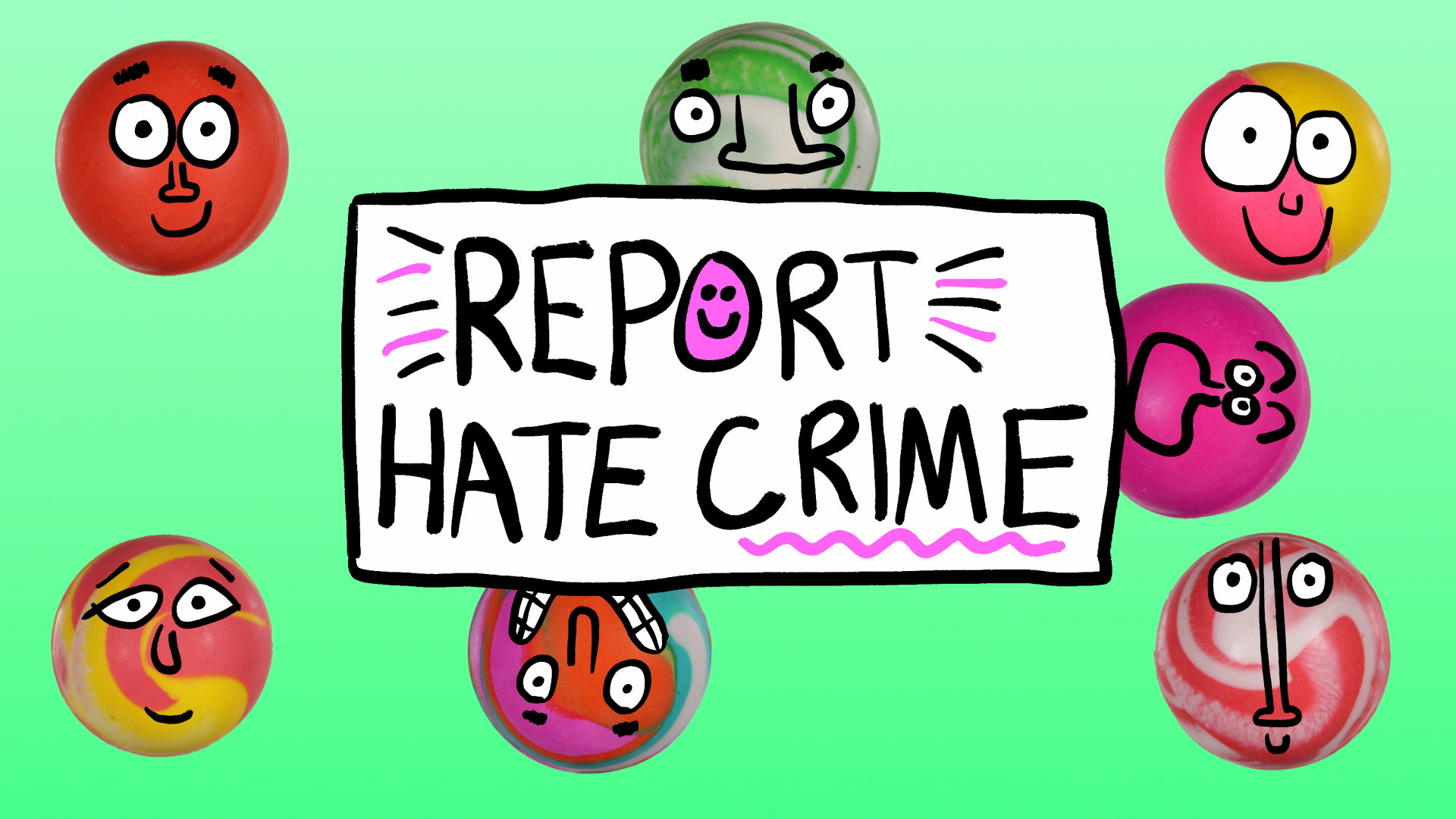 Bouncy balls gathered around a sign that reads Report Hate Crime.