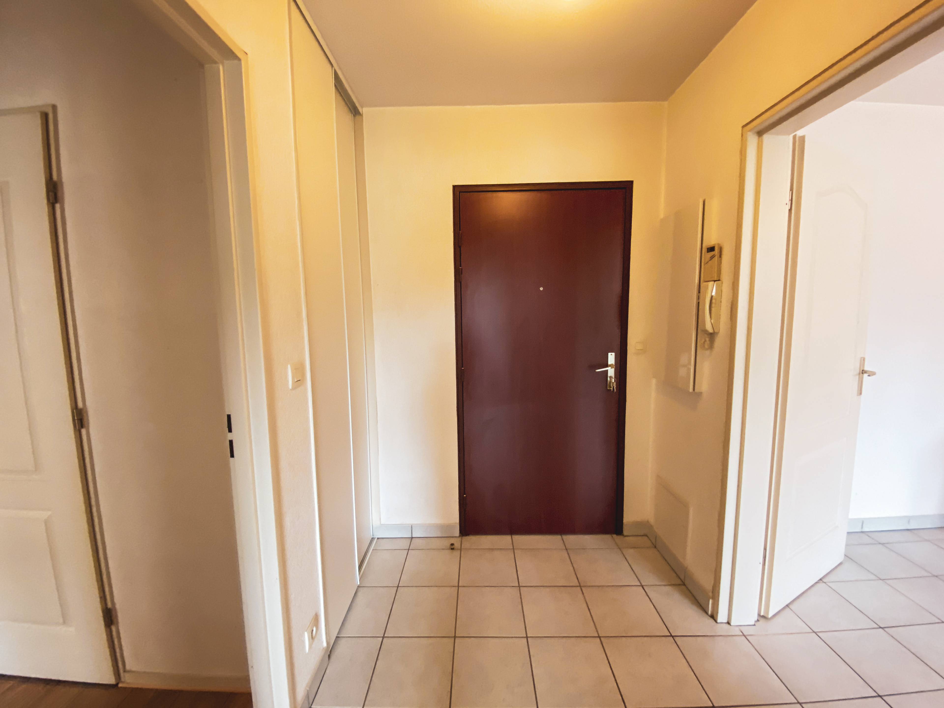 View of front door and hall from inside the apartment