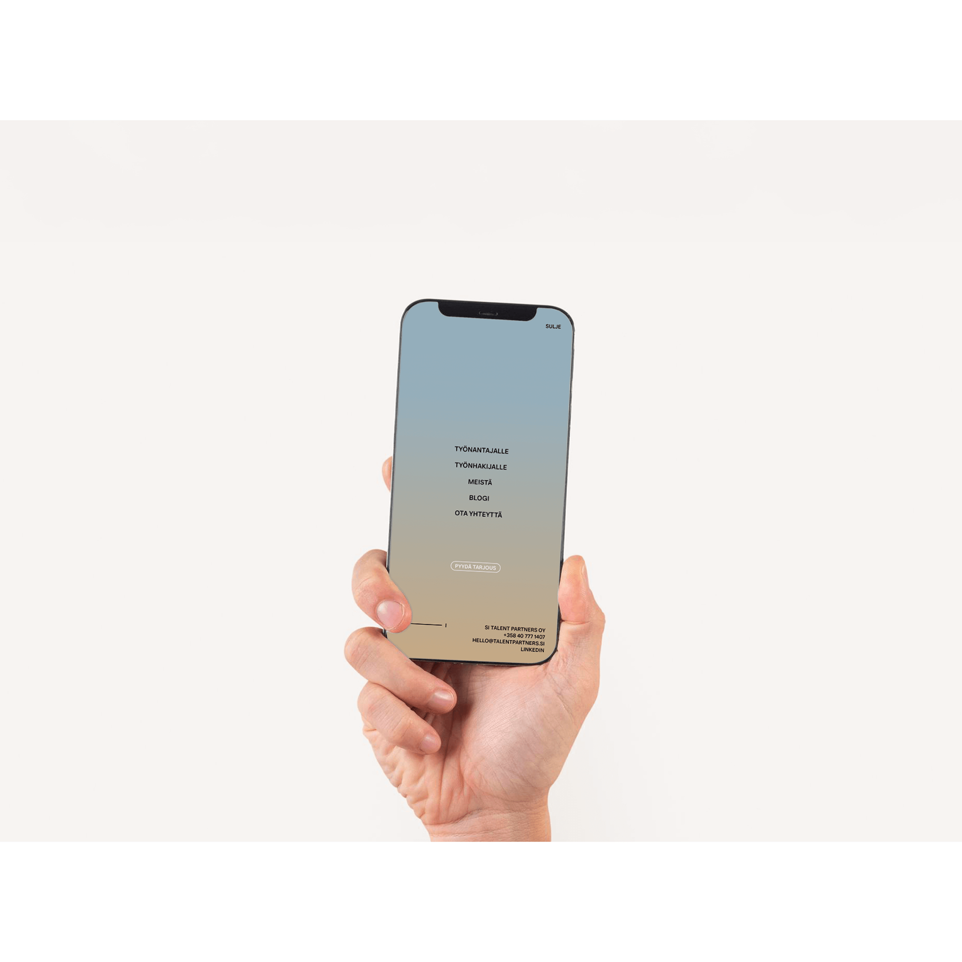 A hand holding a mobile phone showing the website menu of a recruitment agency website