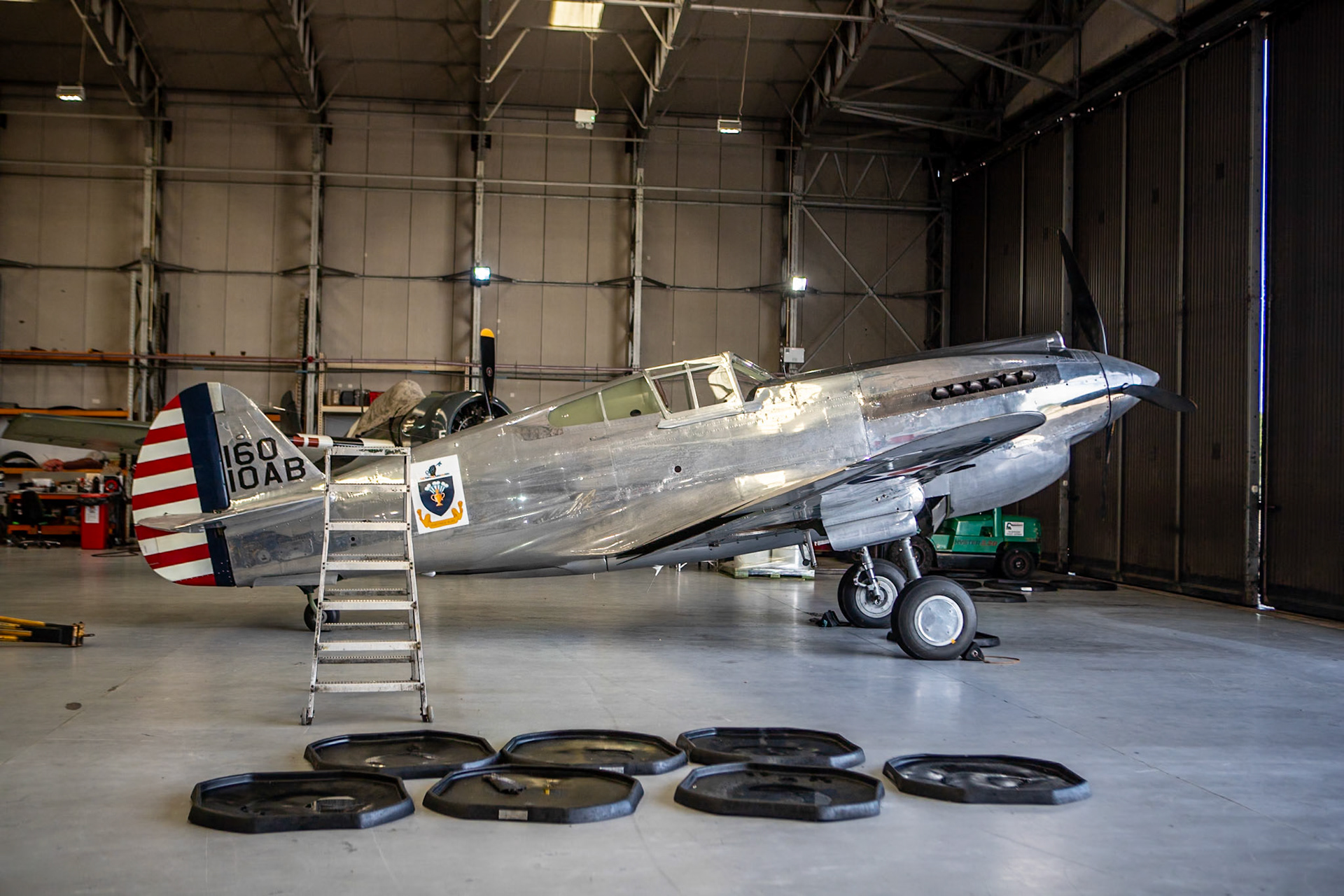 The Curtiss P-40 Warhawk is an American single-engined, single-seat, all-metal fighter-bomber that first flew in 1938. The P-40 design was a modification of the previous Curtiss P-36 Hawk which reduced development time and enabled a rapid entry into production and operational service.