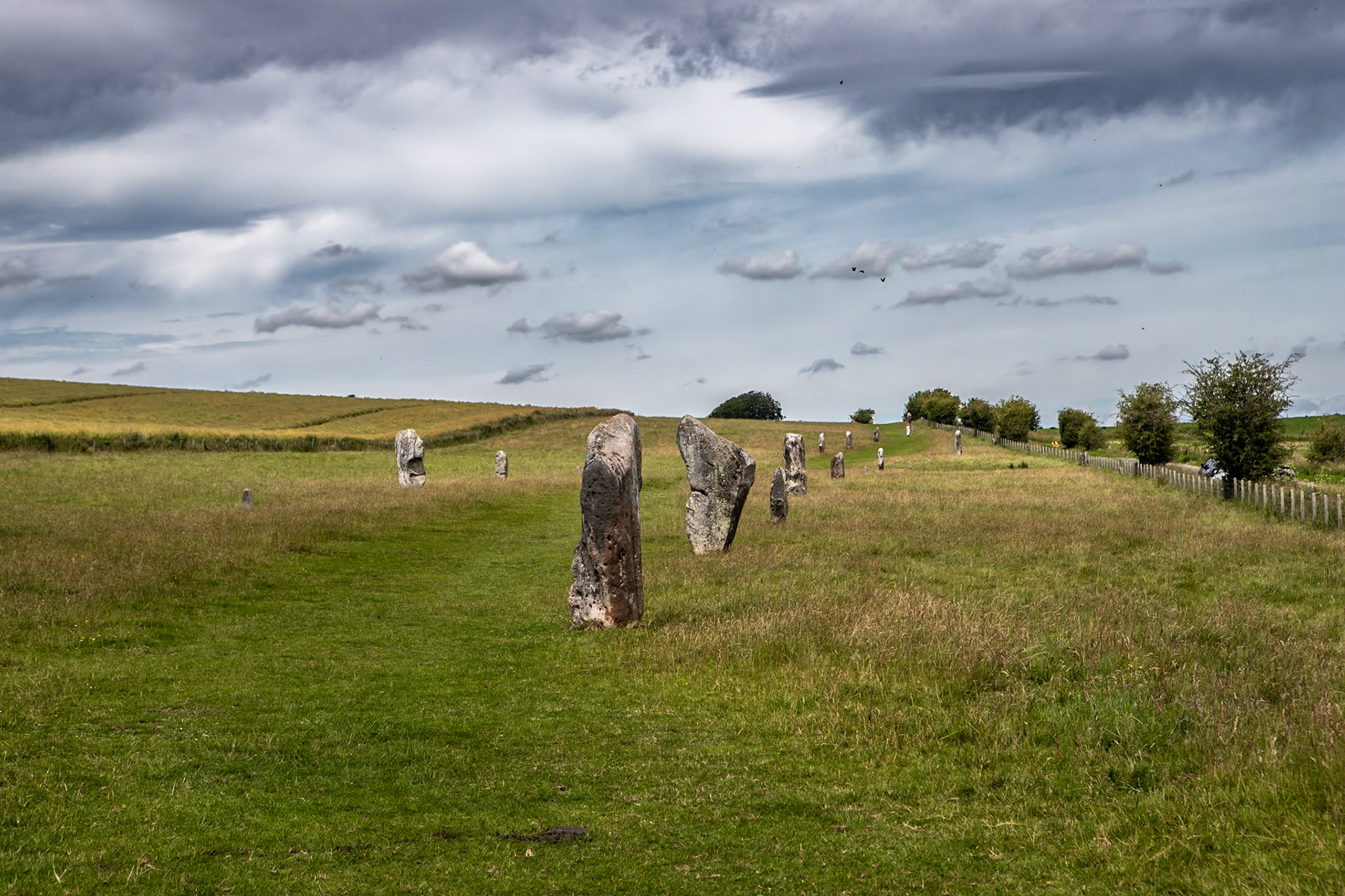 Avebury is a Neolithic henge monument containing three stone circles, around the village of Avebury in Wiltshire, in south-west England. One of the best-known prehistoric sites in Britain, it contains the largest megalithic stone circle in the world.