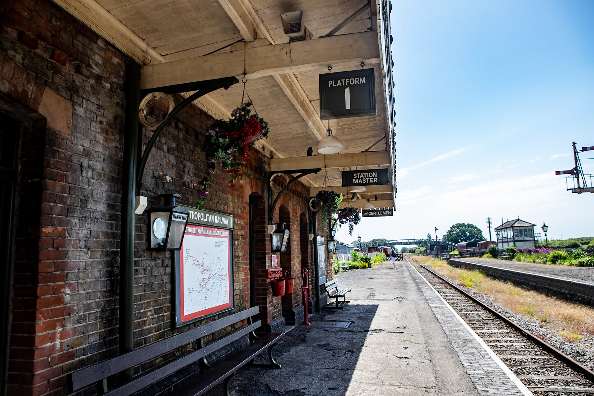 Quainton Road railway station served the area of Quainton, in Buckinghamshire, England; it is sited 44 miles (71 km) from London. Built by the Aylesbury and Buckingham Railway, it was the result of pressure from the 3rd Duke of Buckingham to route the railway near his home at Wotton House and to open a railway station at the nearest point to it. Serving a relatively underpopulated area, Quainton Road was a crude railway station, described as "extremely primitive".