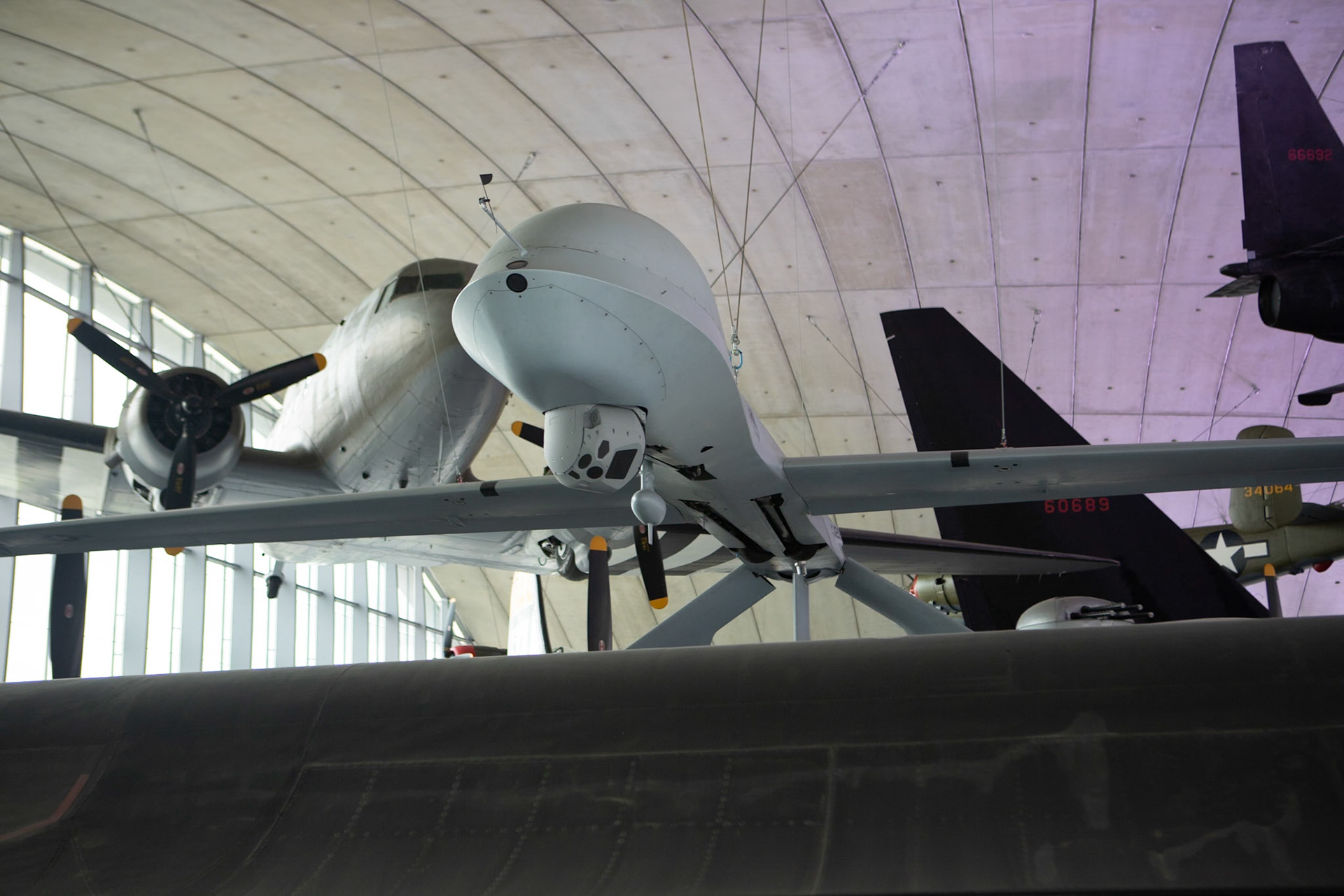 The General Atomics MQ-1 Predator (often referred to as the Predator drone) is an American remotely piloted aircraft (RPA) built by General Atomics that was used primarily by the United States Air Force (USAF) and Central Intelligence Agency (CIA). Conceived in the early 1990s for aerial reconnaissance and forward observation roles, the Predator carries cameras and other sensors. It was modified and upgraded to carry and fire two AGM-114 Hellfire missiles or other munitions.