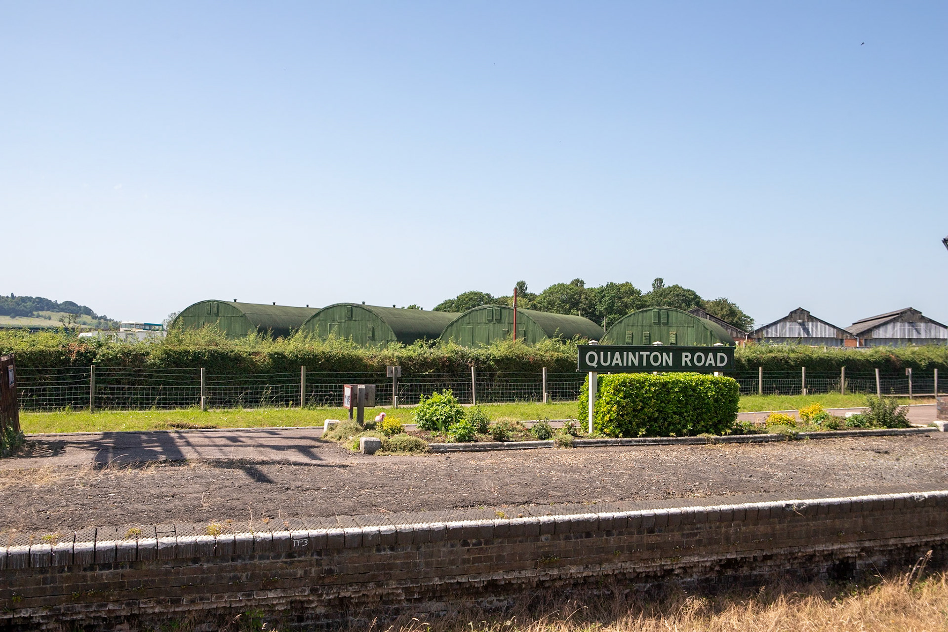 Quainton Road railway station served the area of Quainton, in Buckinghamshire, England; it is sited 44 miles (71 km) from London. Built by the Aylesbury and Buckingham Railway, it was the result of pressure from the 3rd Duke of Buckingham to route the railway near his home at Wotton House and to open a railway station at the nearest point to it. Serving a relatively underpopulated area, Quainton Road was a crude railway station, described as "extremely primitive".