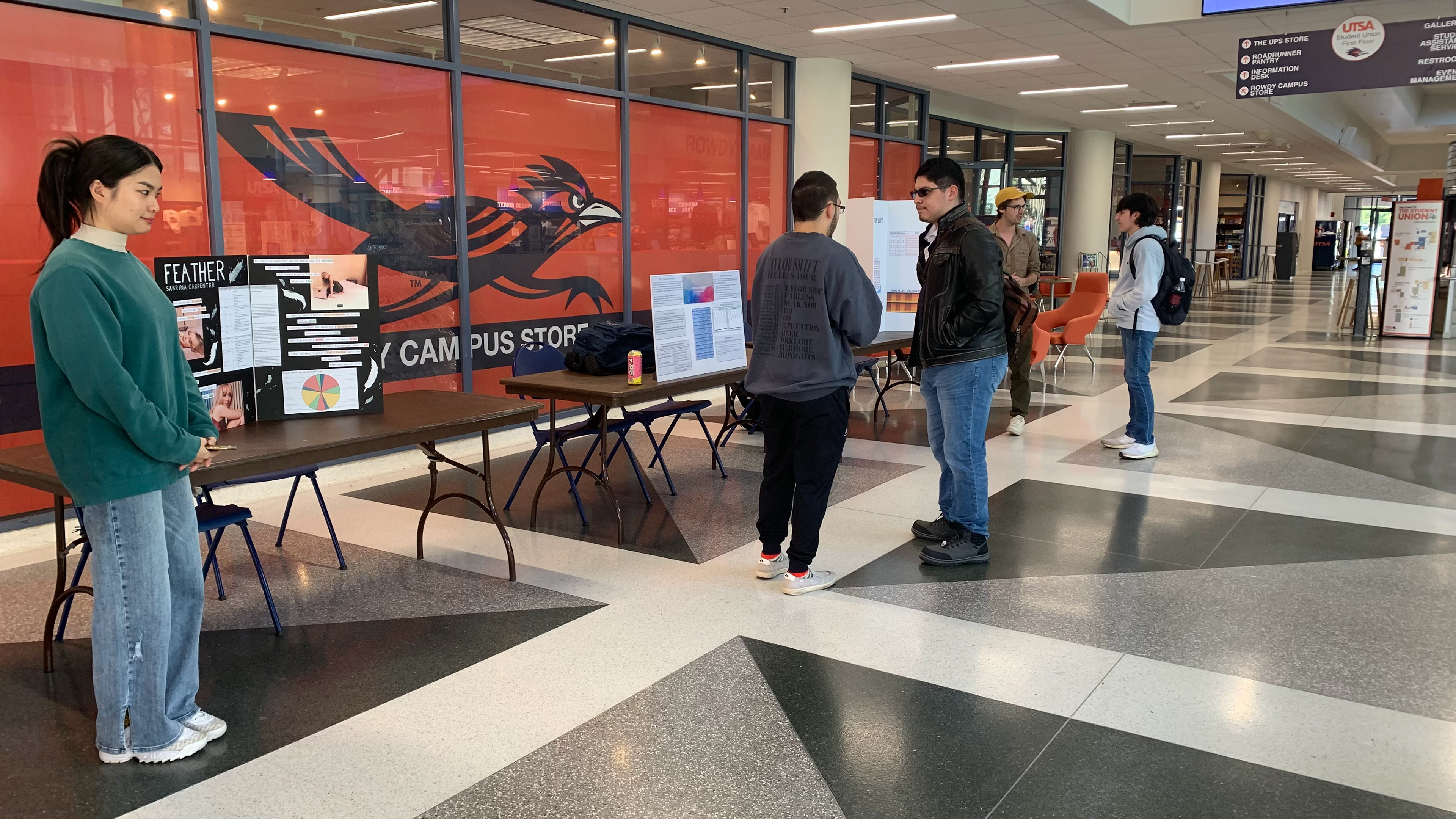 Wide shot of three presentation poster stations during one of the quieter moments of the Poster Presentation Expo.