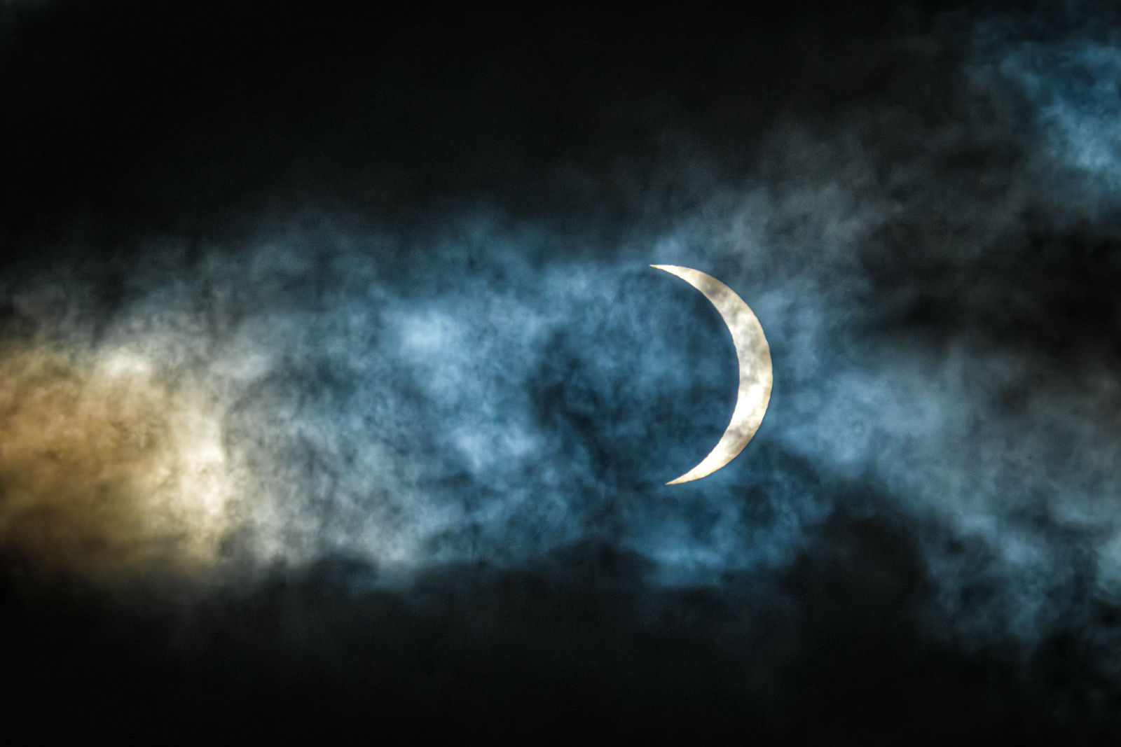 Eclipse Through the Clouds
