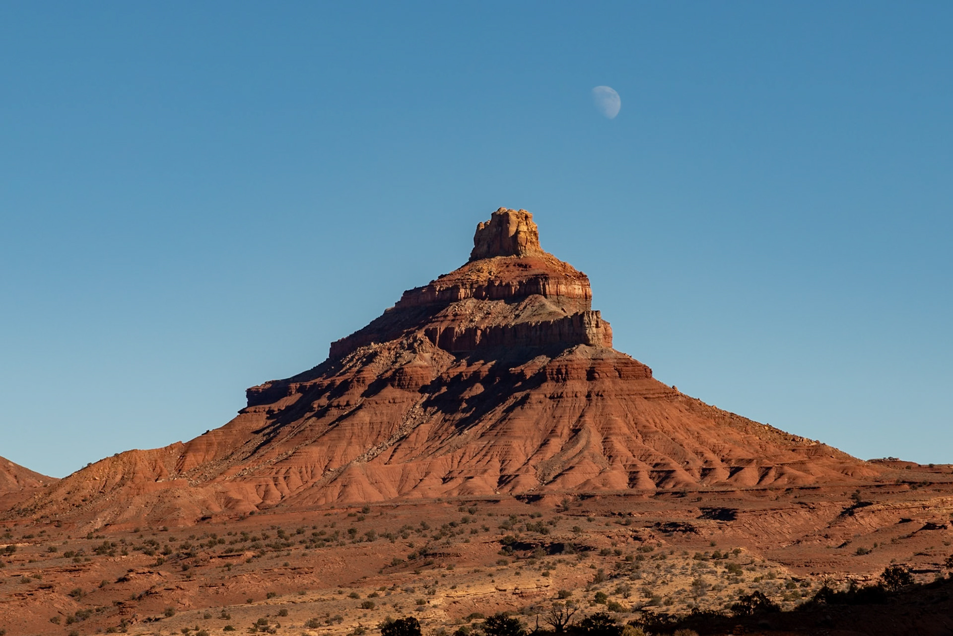 At mid-day the moon peeking over a butte in the Reds Canyon area of the San Rafael Swell.