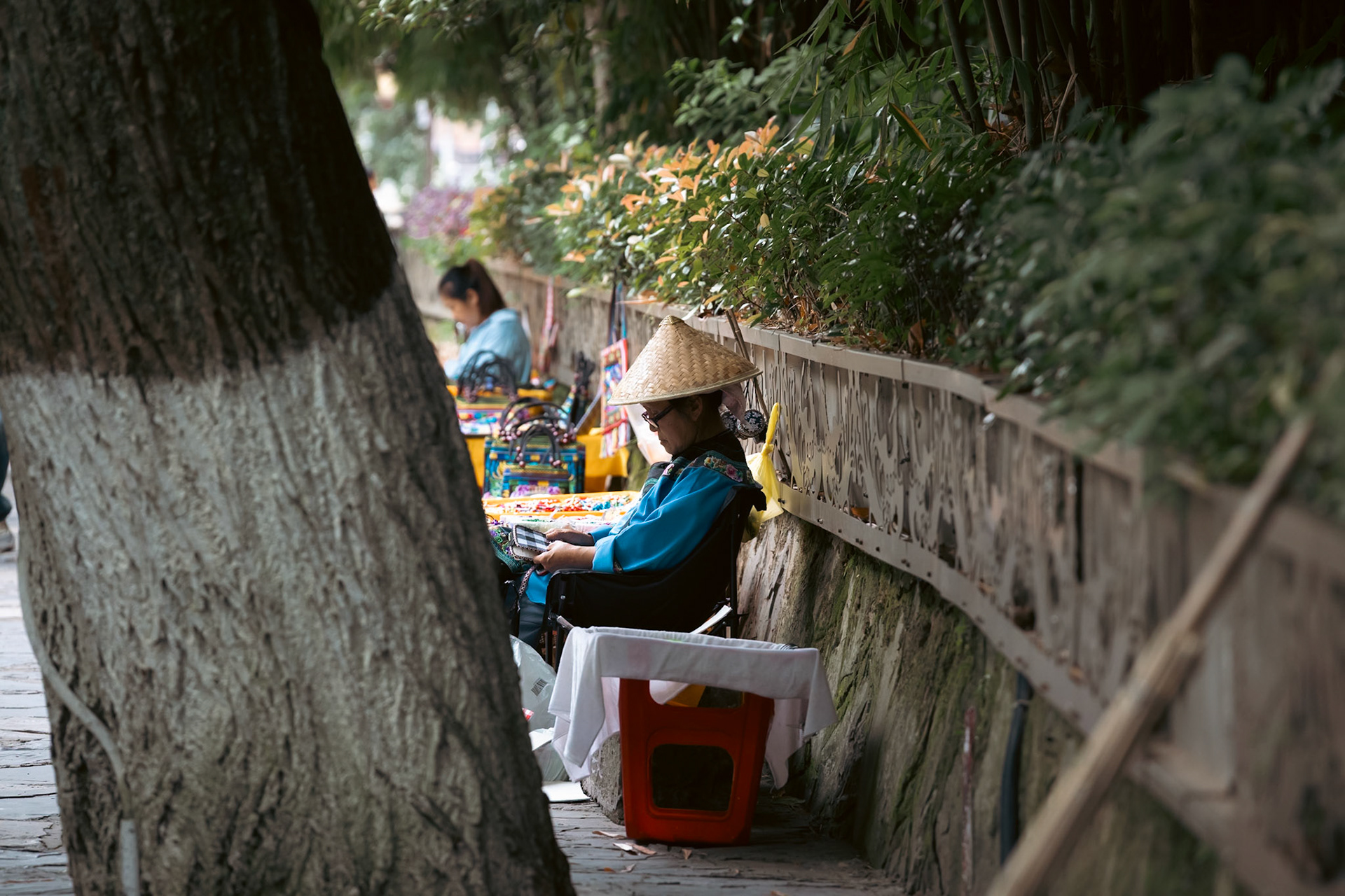 Woman sewing, Fenghuang Ancient City