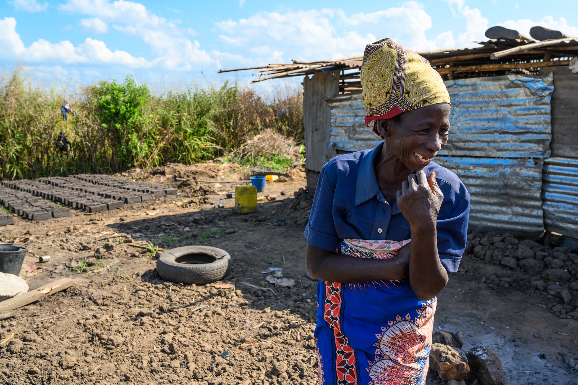 Joana Antonia laughs with visitors on the site of her former home destroyed by Cylone Idai. Her home is in the Josina Michelle neighborhood in Nhamatanda, Mozambique. She received an emergency distribution of food and sanitation items from ACT Alliance partner CEDES following the storm.