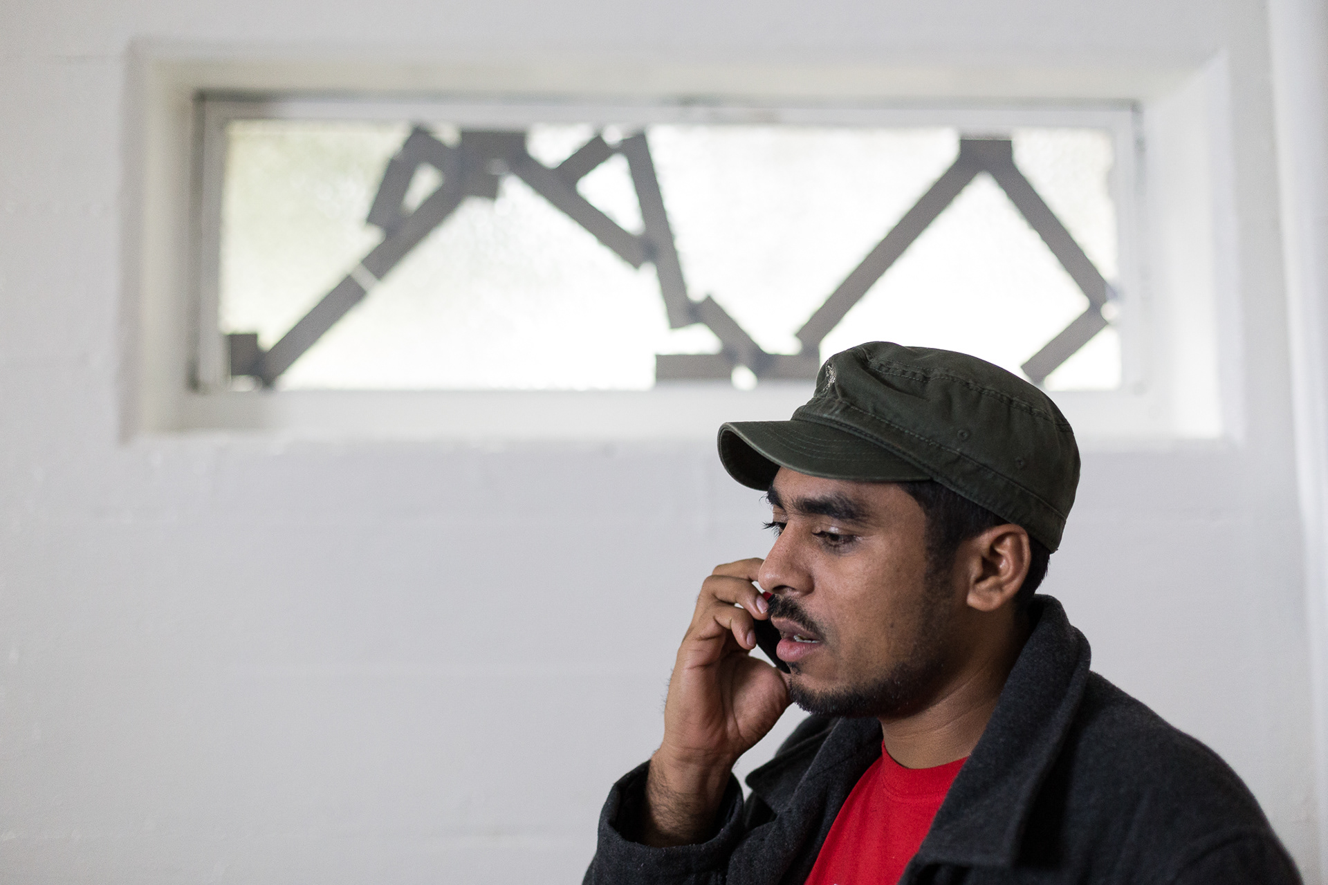 Francisco Aguirre makes a phone call from a room in the basement of Augustana Lutheran Church in Portland, Ore.