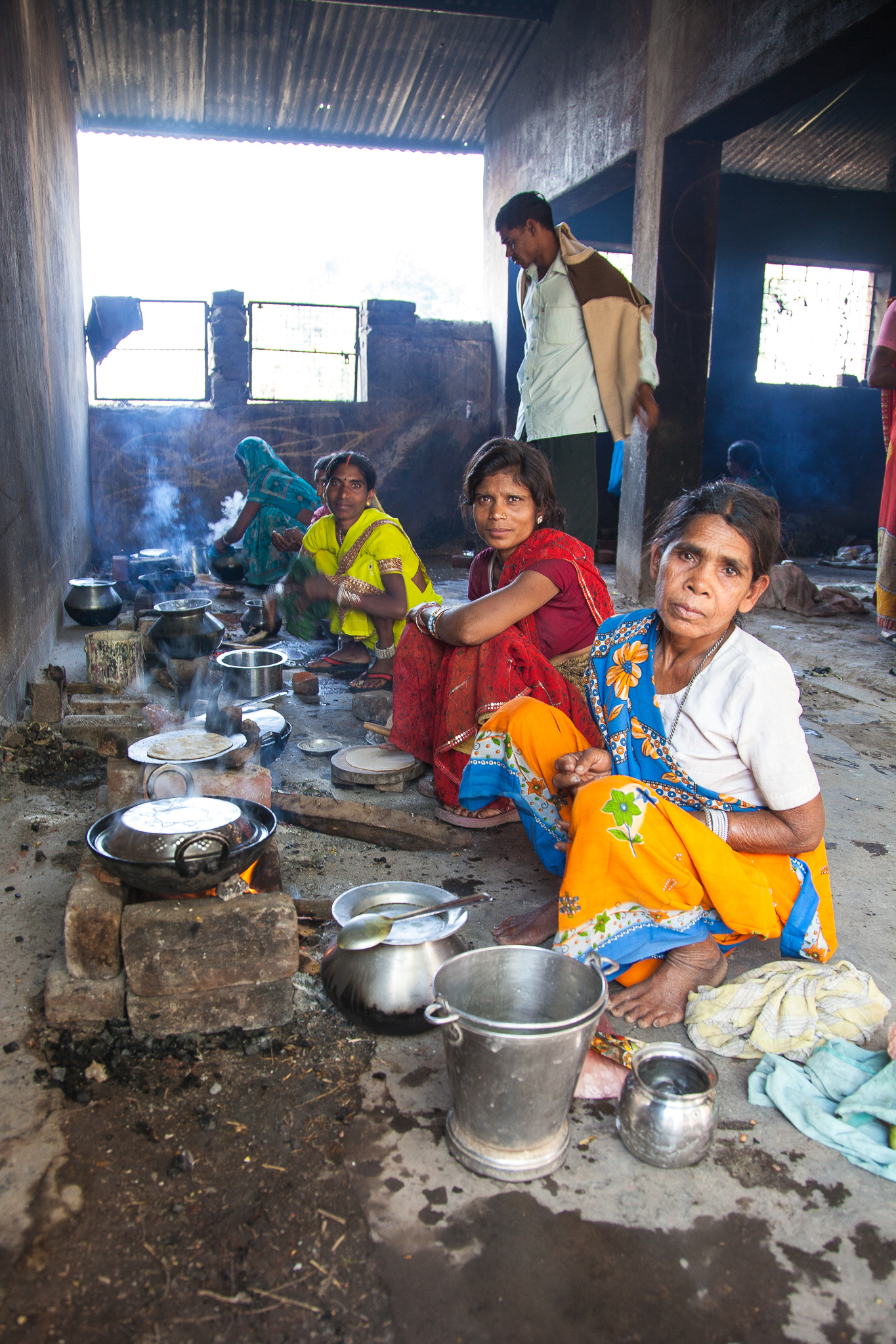 Women cook for family members over small wood fires at the Mungeli Christian Hospital.