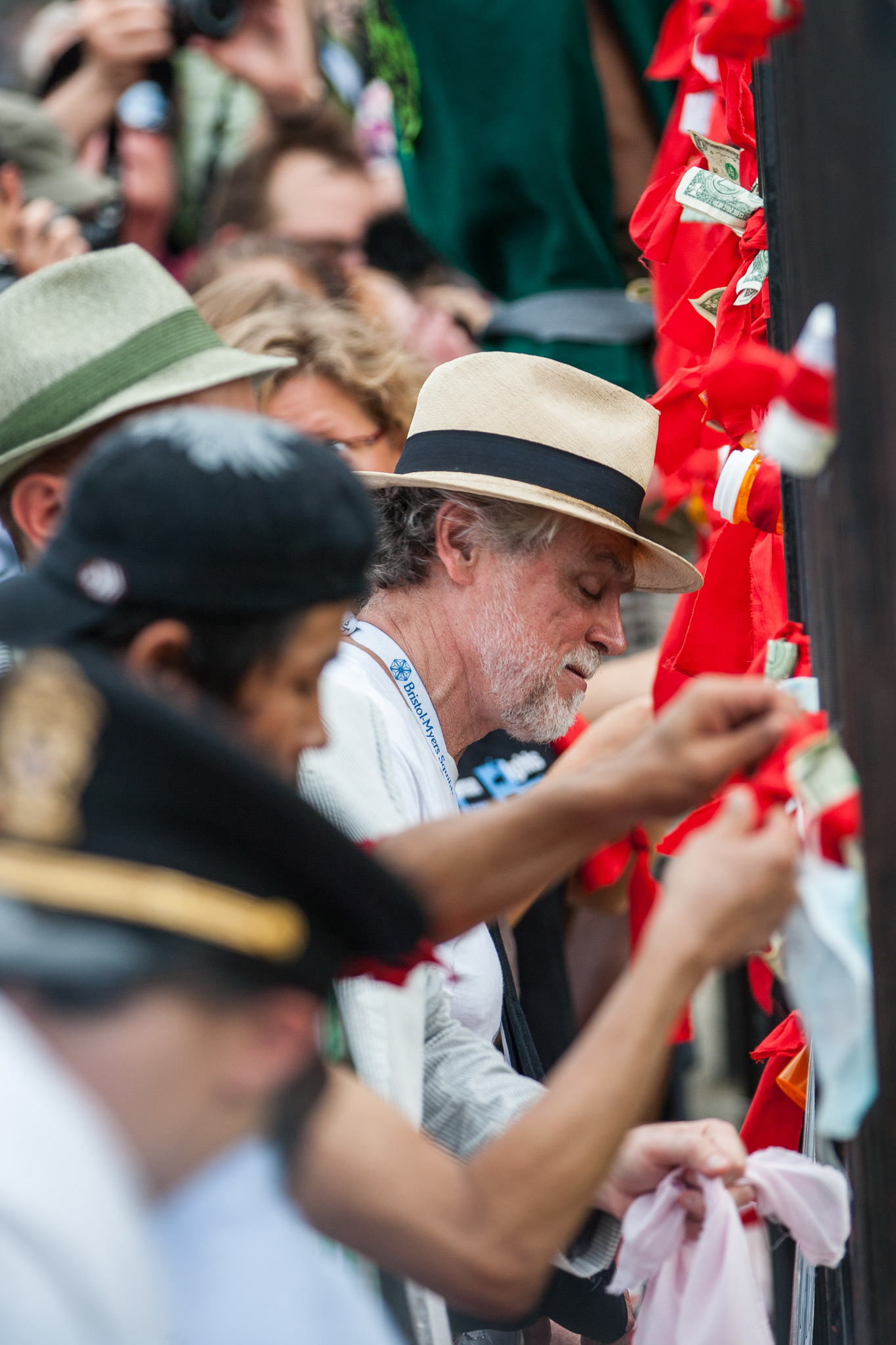 Protestors tie pill bottles, condoms and dollar bills to the fence outside the White House calling for greater access to inexpensive treatment options for HIV/AIDS during the 2012 International AIDS Conference.