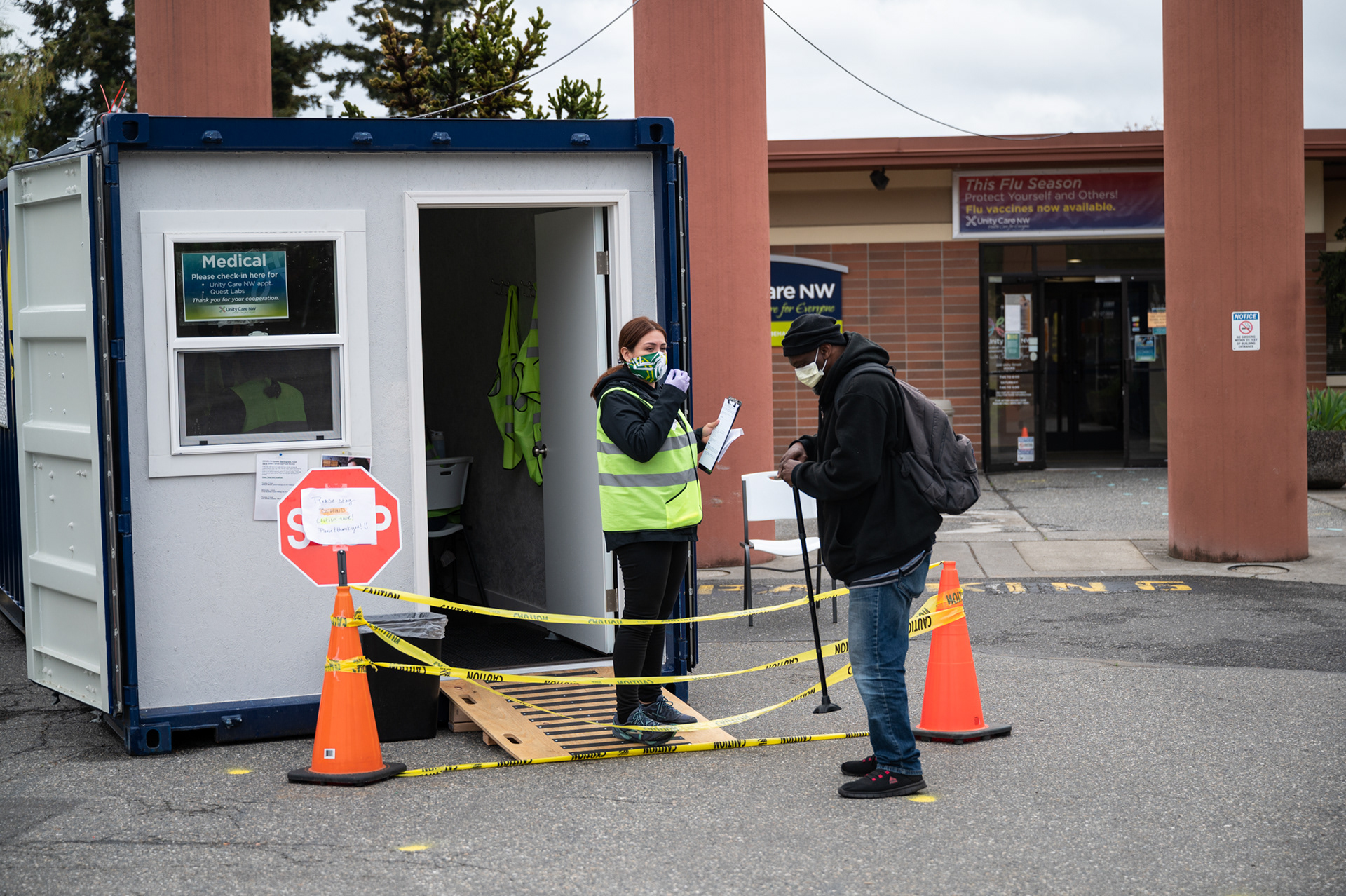 Curb-side screeners utilize a shipping container as an office at Unity Care NW in Bellingham, Washington to question and scan patients and visitors for COVID-19 symptoms.