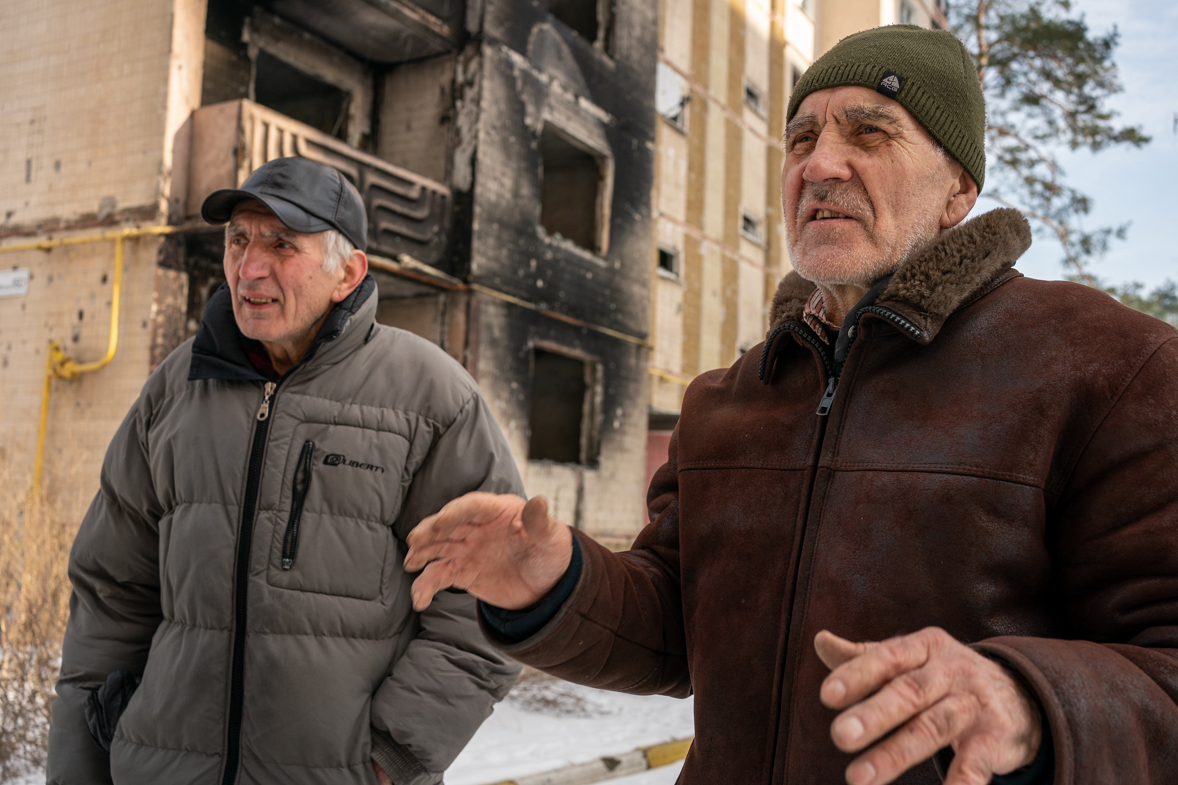 Brothers Basil and Nicolai Knutazev stand in front of Basil’s apartment building in Irpin, Ukraine, that was destroyed by Russian artillery in the early days of the invasion. Nicolai, who’s apartment was across the parking lot, was also destroyed.