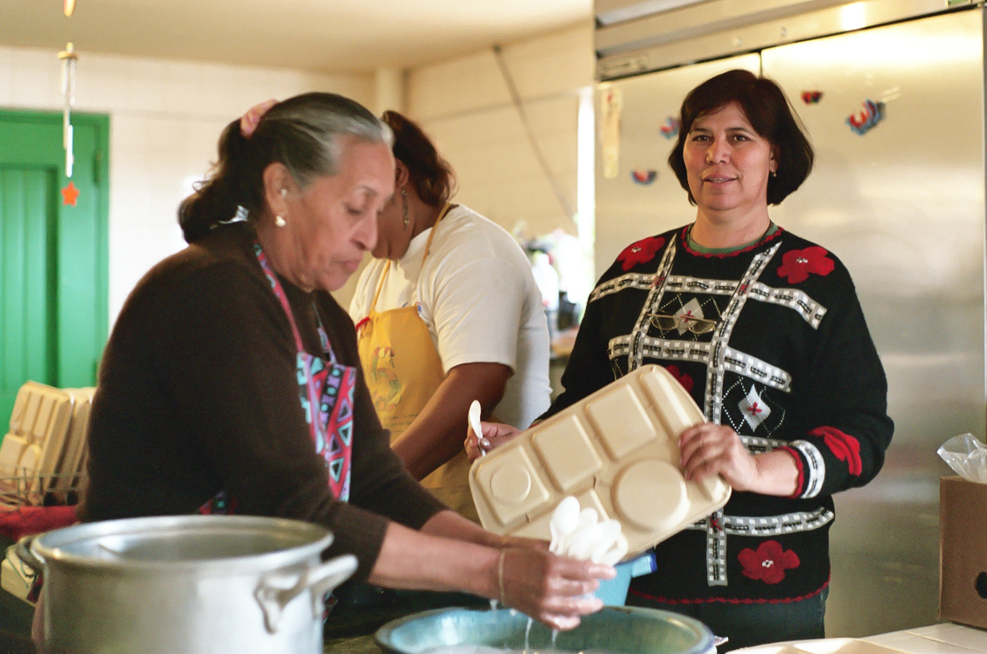 Neighborhood women are the backbone of finance and labor for the services provided by Casa de la Misericordia. Here they are cleaning up after a lunch meal.