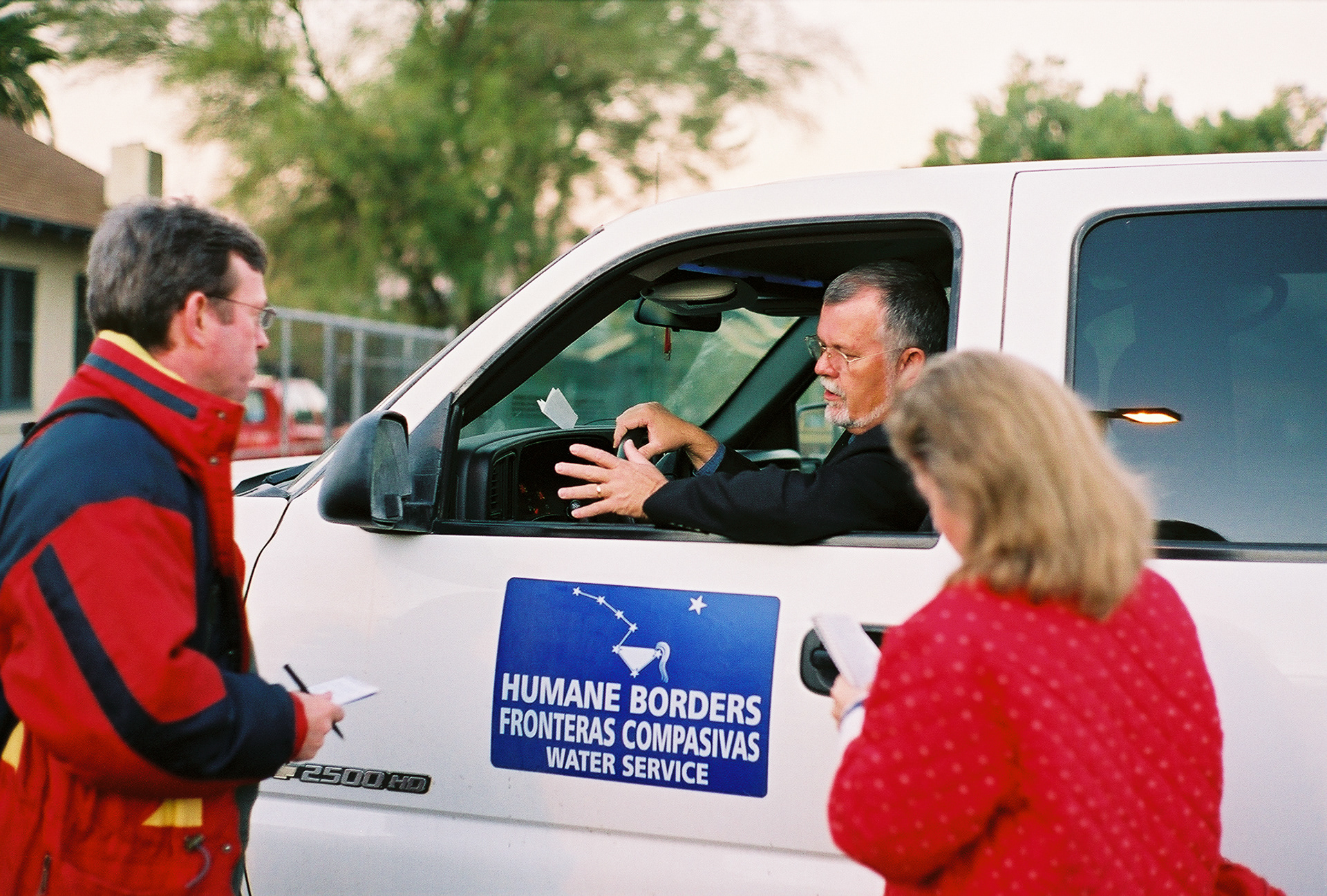 Rev. Robin Hoover gives last minute instructions to replenishment truck driver Marissa Rice as she heads to the desert to refill Humane Borders watering station barrels.